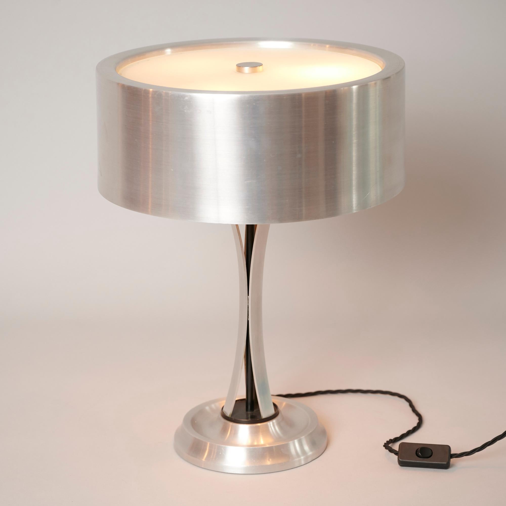 Brushed nickel table light with frosted glass by Oscar Torlasco.

Shade rotates and tilts to all angles...

Takes three ES candle bulbs. 

Re wired for Europe and US. (suitable plug needed for Europe and US).