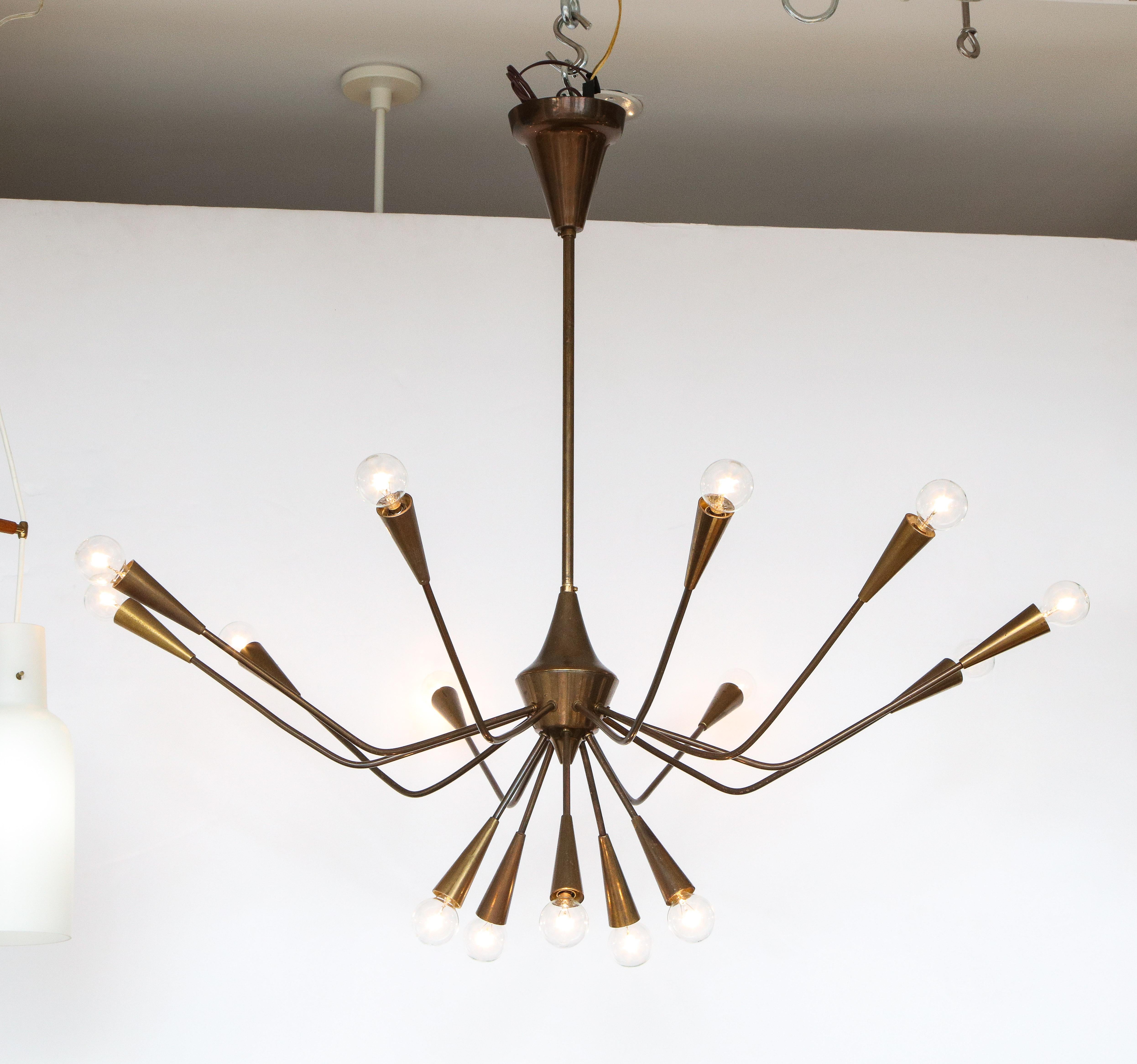 Stunning 1960's modernist patinated brass 15 arm chandelier designed by Oscar Torlasco for Lumi, in vintage original condition with beautiful patina, the chandelier have been professionally rewired and is ready to use.