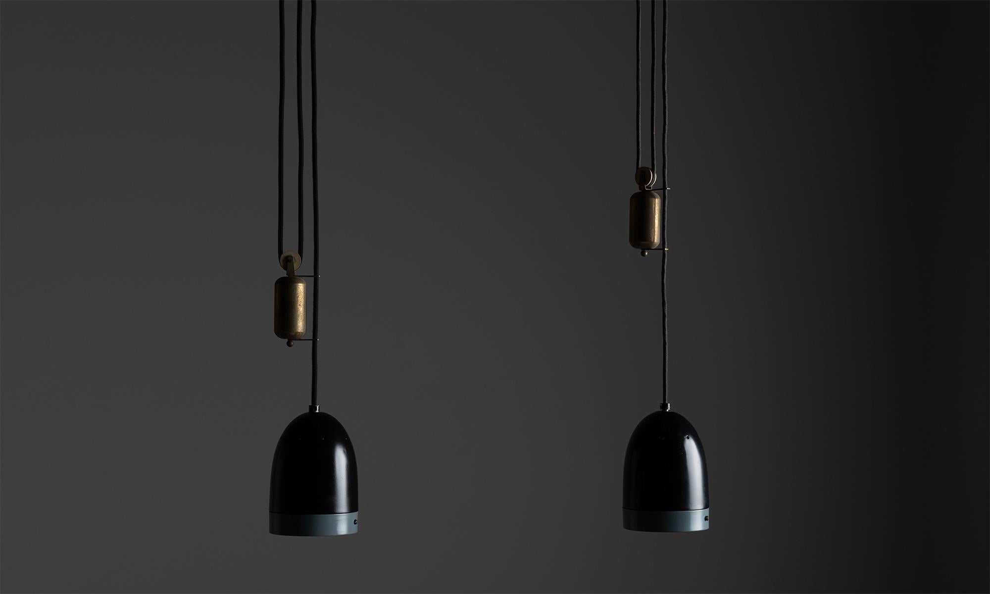 Oscar Torlasco pendants

Italy circa 1950

Two-tone painted aluminum shade with brass pulley, metal diffuser and internal mirrored 

Reflector.

Measures: 5”diameter x 7” height ( light) / 46.25” H (overall).