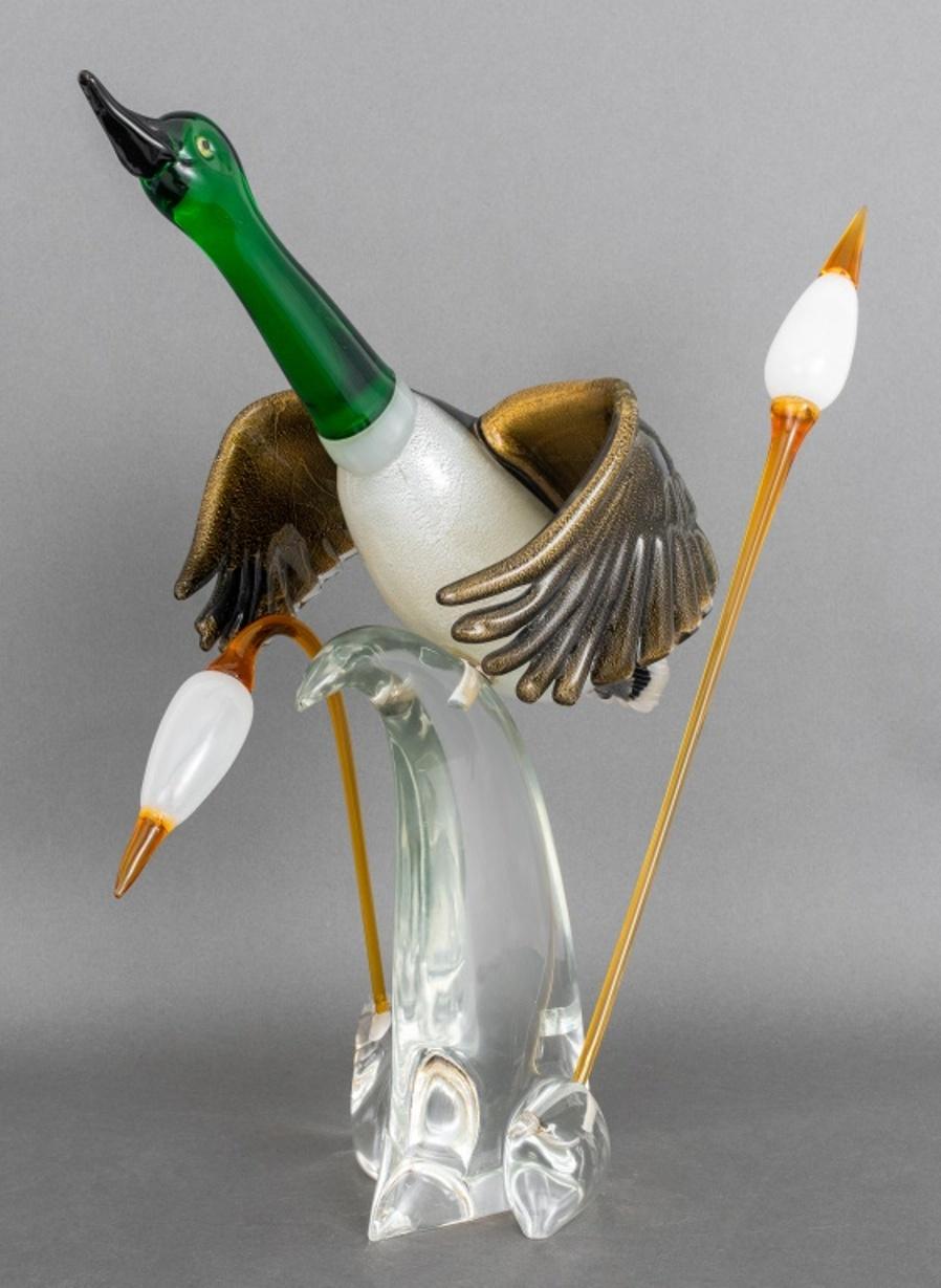 Oscar Zanetti (Italian, b. 1961) Murano art glass sculpture of a mallard duck in flight, comprised of a duck on a clear base issuing two cattails, with Zanetti label to base, and signed 