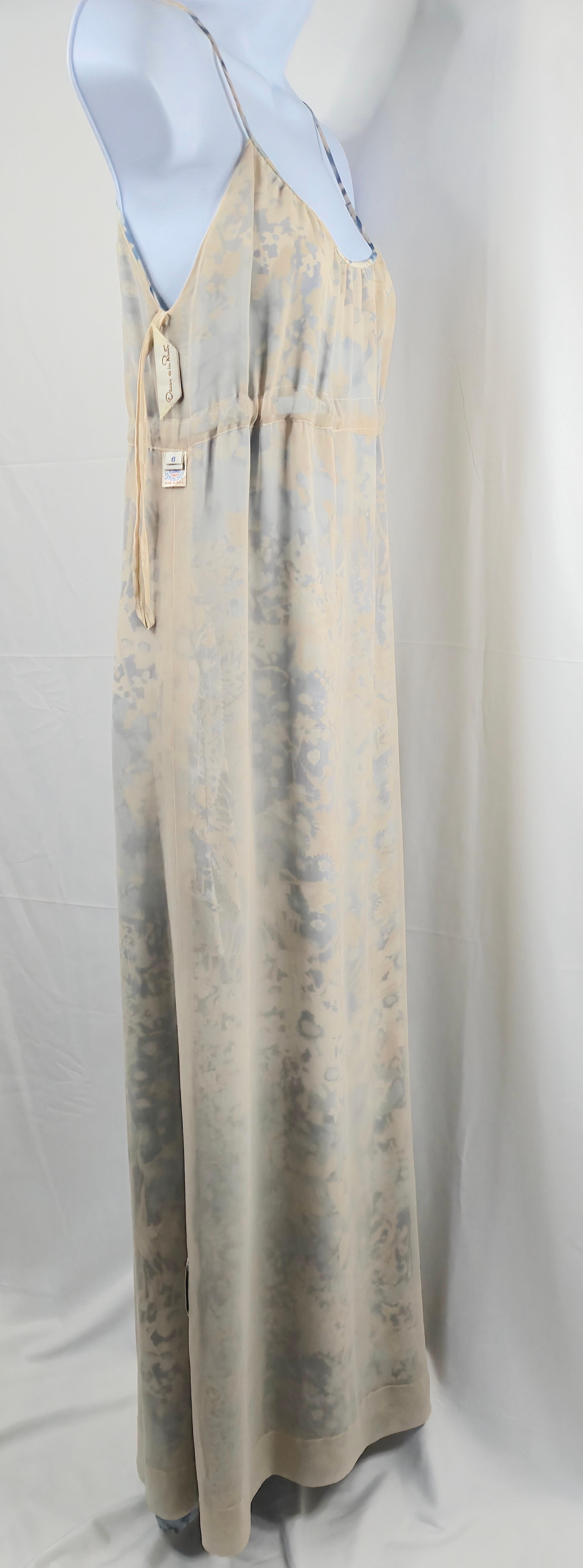 Designed by U.S.-based Oscar de la Renta (1932-2014) for his 1975 Resort collection, this deeply-draping two-layer empire-waist silk gown maxi dress is handpainted in a blue-cream-and-white floral pattern. To date the dress, we found a GettyImages