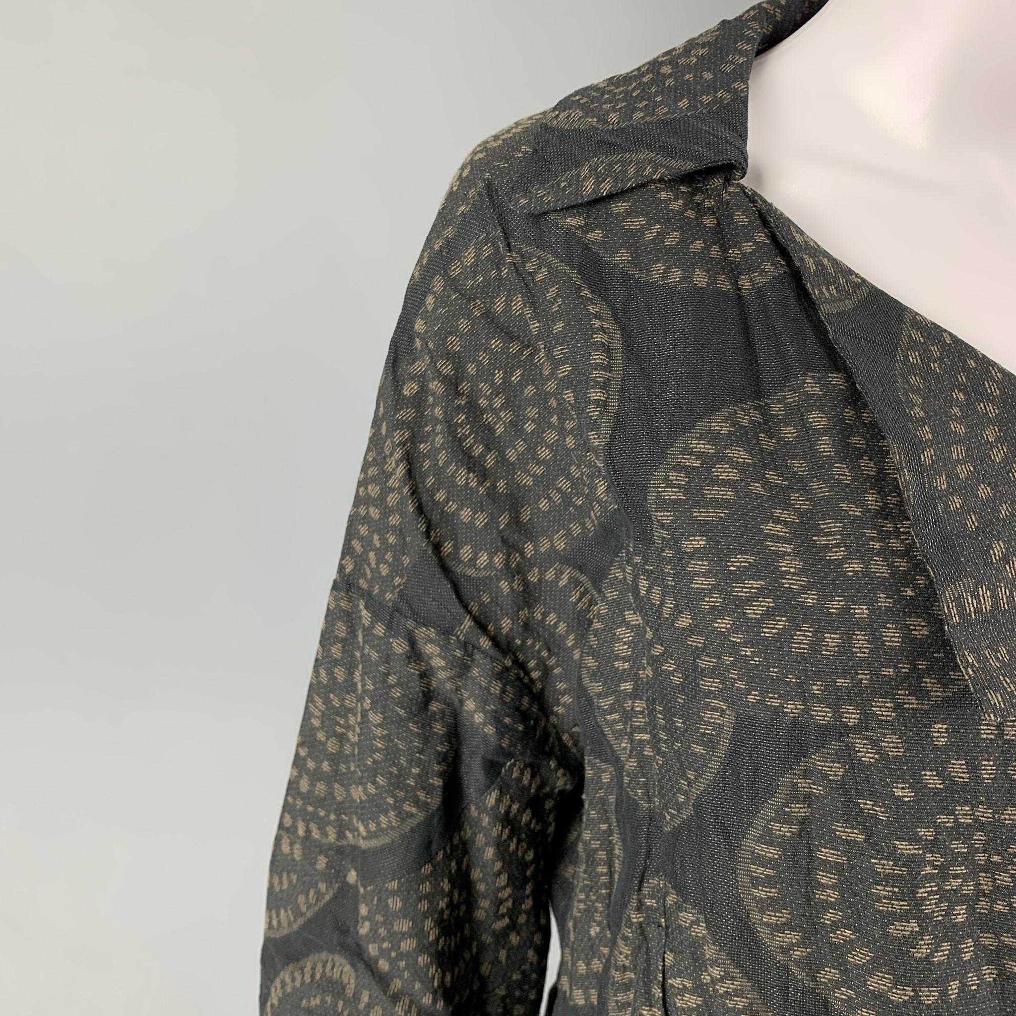 OSKA jacket comes in a black & taupe cotton featuring a circle print throughout, cropped style, and a buttoned closure. 

Very Good Pre-Owned Condition.
Marked: II

Measurements:

Shoulder: 25 in.
Bust: 38 in.
Sleeve: 12.5 in.
Length: 21 in.