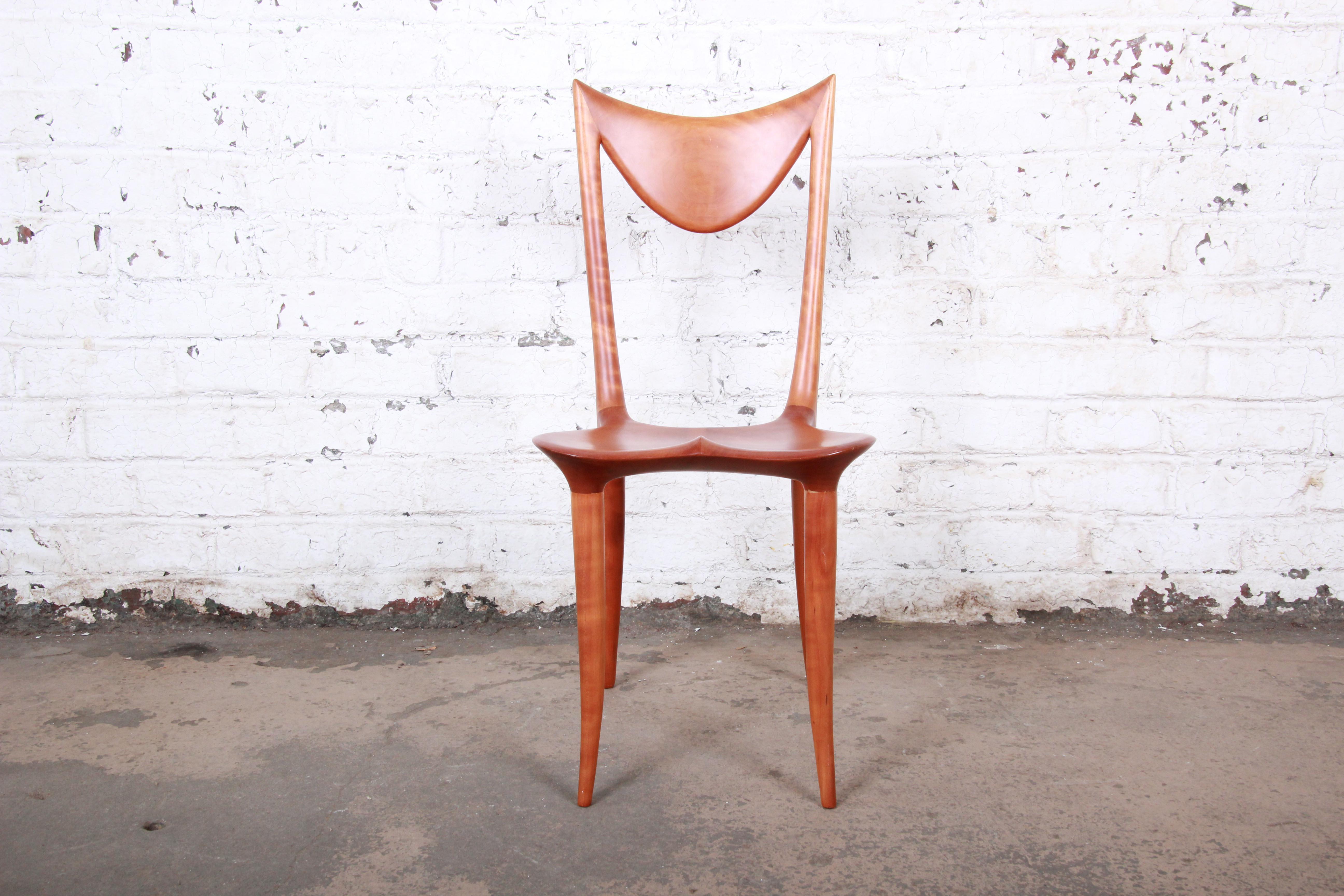 A rare and exceptional studio craftsman sculpted chair by world-famous Slovenian industrial designer and artist Oskar Kogoj. This sculpted solid cherry wood chair, known as the 