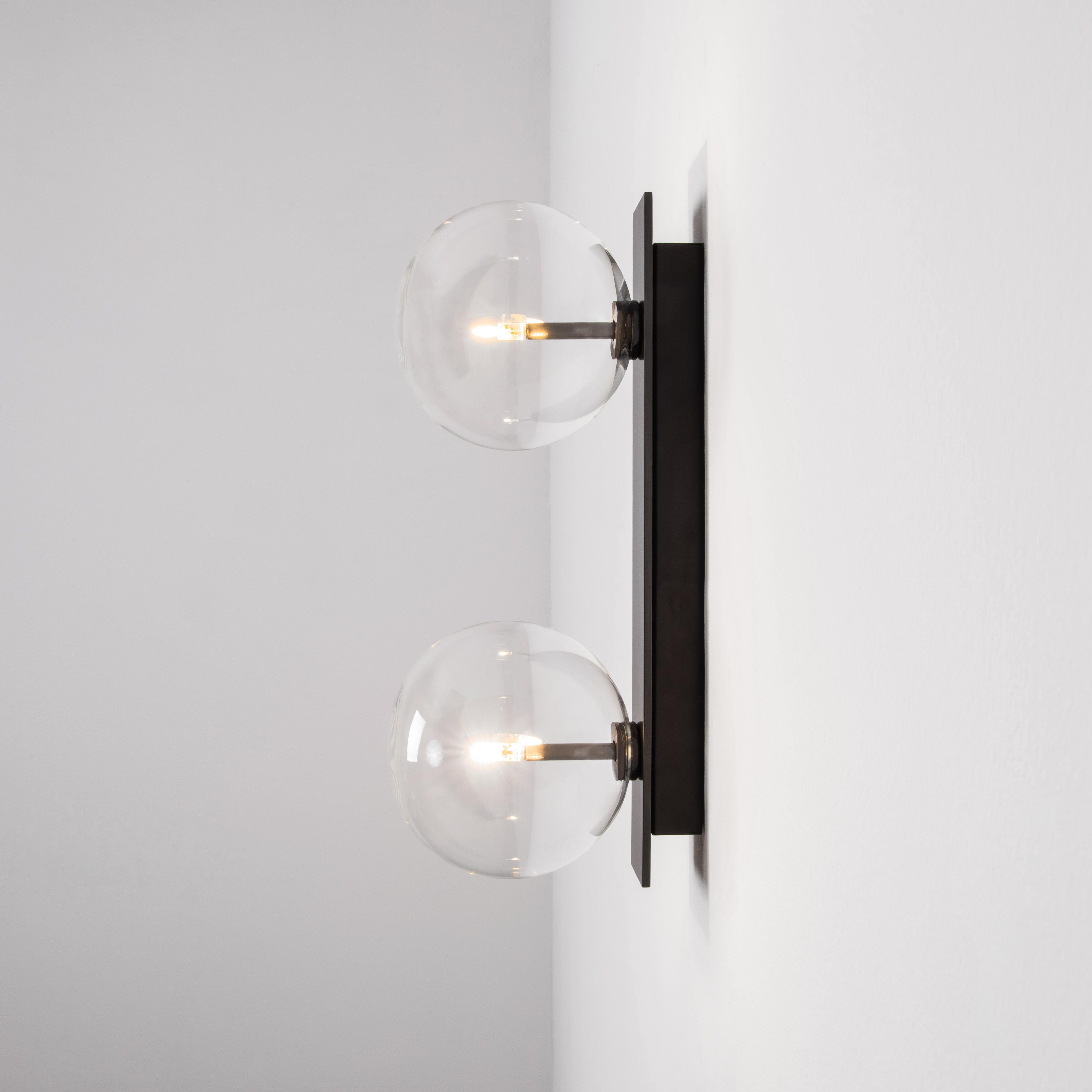 Oslo Dual wall sconce by Schwung
Dimensions: W 15 x D 19 x H 40 cm
Materials: Black gunmetal, hand blown glass globes

Finishes available: Black gunmetal, polished nickel, brass
 

Schwung is a German word, and loosely defined, means energy