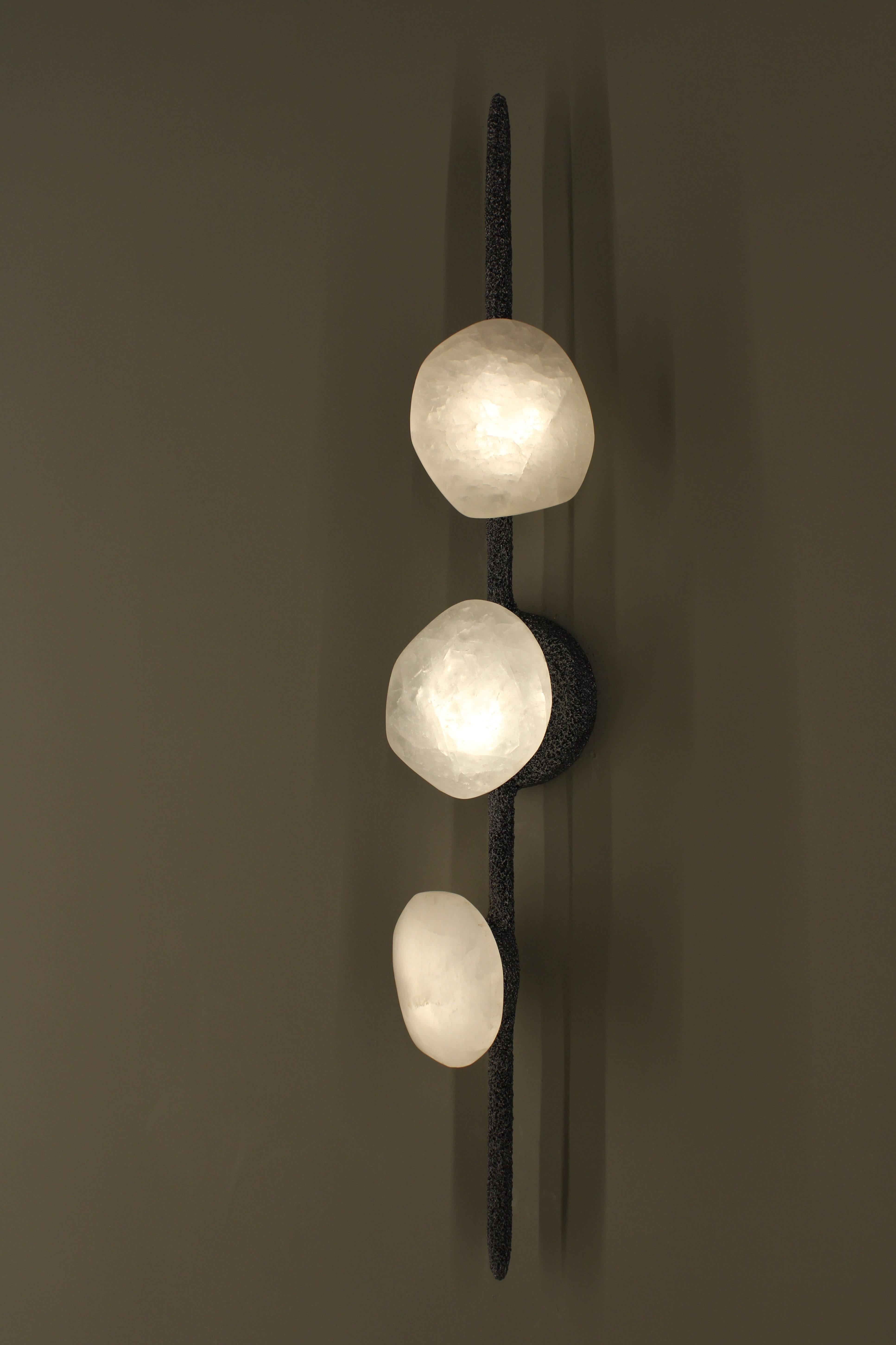 Oslo I Wall Lamp with White Quartz And Hand-Blown Glass Details by Aver
Dimensions: D 9 x W 12 x H 76 cm.
Materials: Smoked glass, white quartz, and metal.

Available in different finishes. All our lamps can be wired according to each country. If