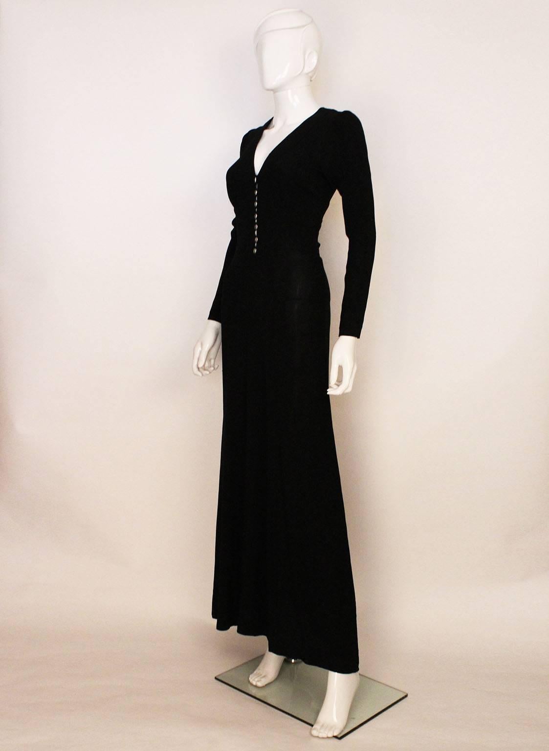 A very chic dress by British designer Ossie Clark. In his favorite fabric, moss crepe, this dress is elegant and easy to wear. The  sleeves are slightly puffed at the shoulder and narrow towards the wrist. There is a v neckline, with gathering under