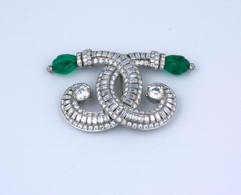 Wonderful Art Deco Diamond and Emerald brooch from the 1930's, set in platinum by Ostertag, France. This lovely design is very reminiscent of Coco Chanel's logo who was his neighbor in the period, where he was located at 16 Place Vendome. 
Conjoined