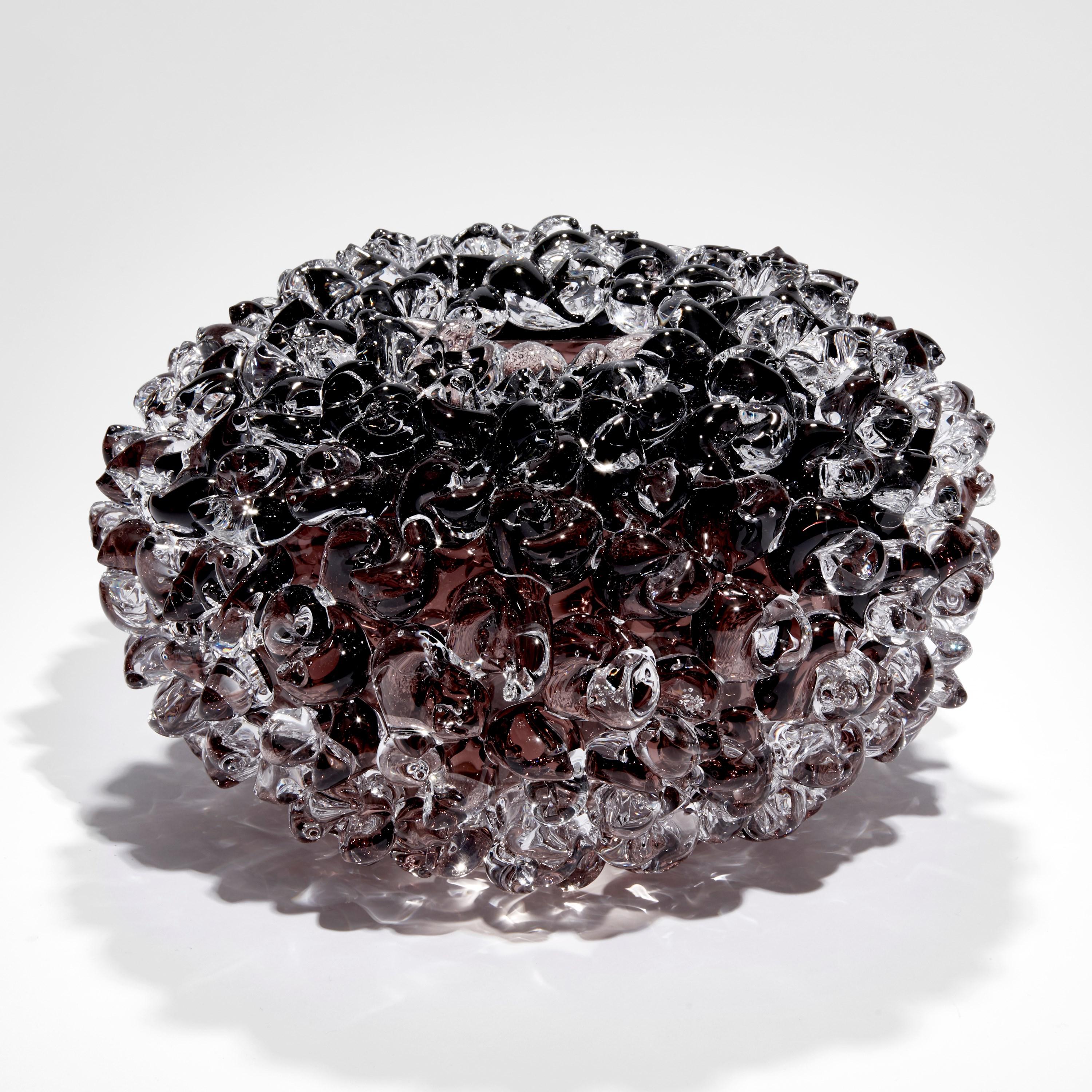 'Ostreum in Rauch Topaz' is a unique handblown and sculpted decorative glass centrepiece by the British artist, Katherine Huskie.

Huskie has been working with glass for over 10 years. Having started experimenting with glass at college she