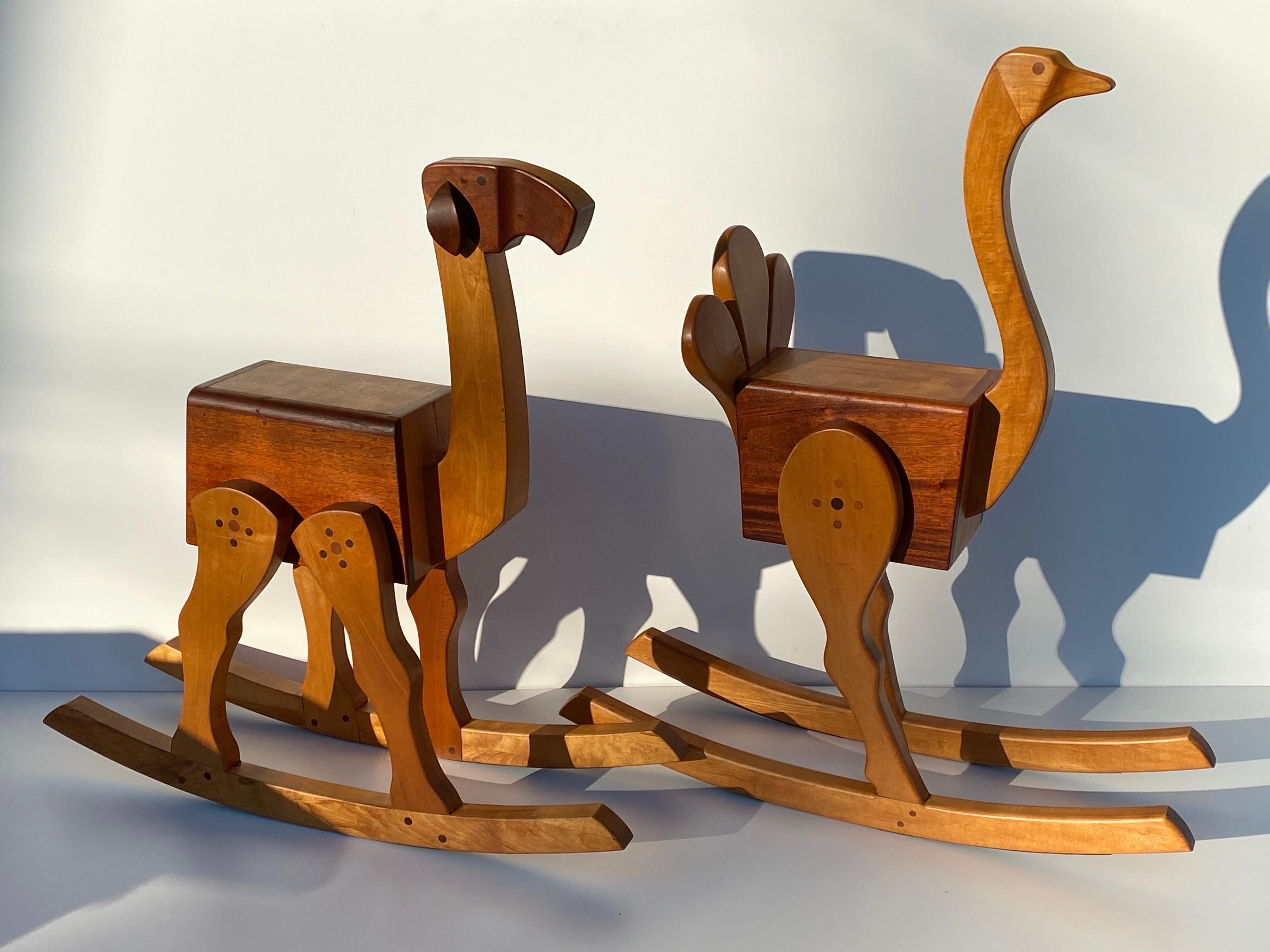 One of a kind set of two ostrich and camel adult size carousel rocking chairs, also can be used as barstools.
Stamped BJ 1979 in the style of Kay Bojesen made of mahogany and white maple. True conversation piece !