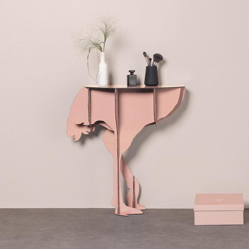 Diva, the aerial ostrich, seems ready to spread her wings in a daring dance, defying the laws of gravity with feet that only seem to skim the ground.

Intended to be fixed against a wall, the elegant and practical console surprises with its feminine