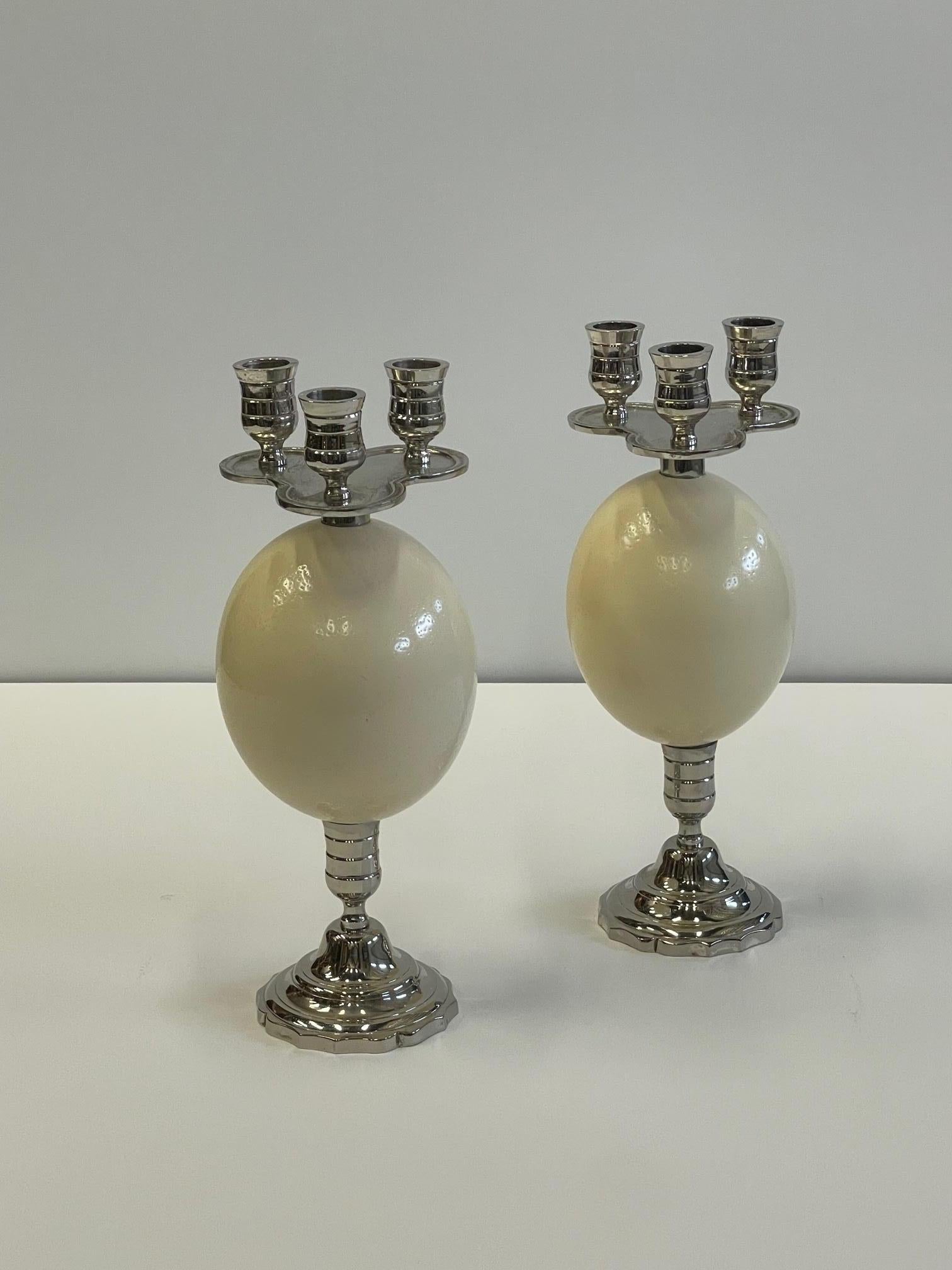 Eye catching pair of ostrich egg and silverplate candlesticks having places for 3 candles in each.