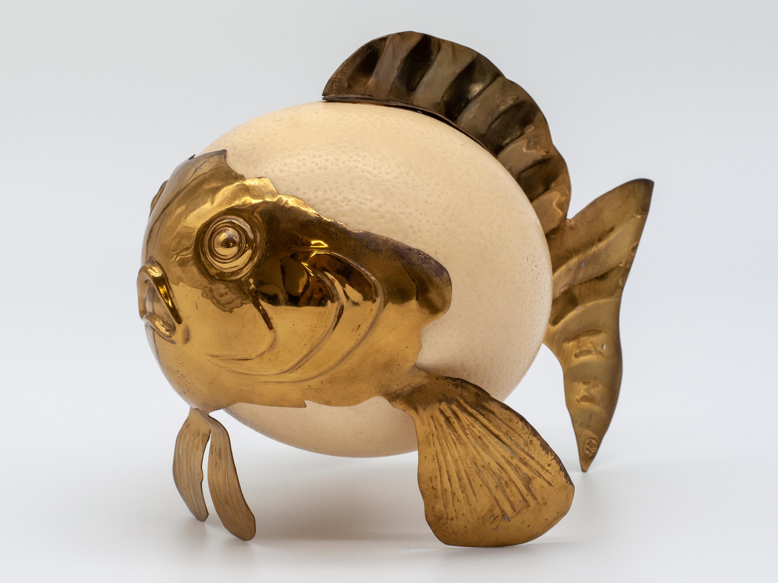 A makers mark dates this unique creation to the 1860s. Of unknown origin, this ostrich egg was transformed into a blowfish using brass fins and facial features. Resting on it's fins it has a prominent face. In good condition, extremely fragile.