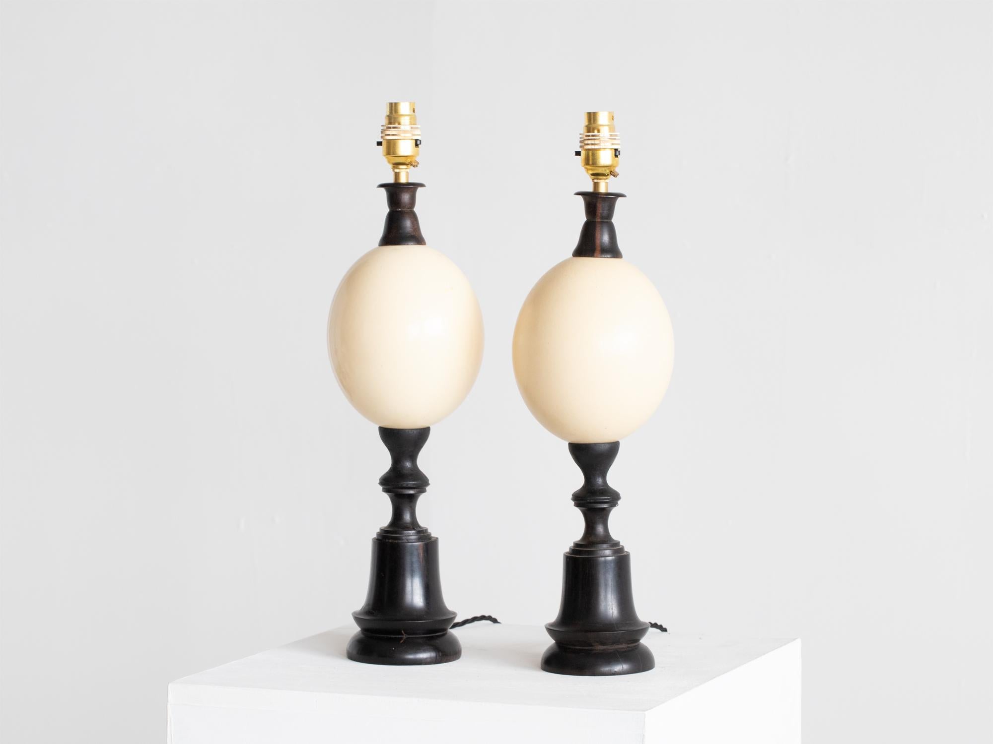 A pair of ostrich egg table lamps. French, early-mid 20C.

Hand-turned ebonised columns with subtle variations in size.

Professionally re-wired.

Sold as a pair.

46 x 12 x 12 cm

18.1 x 4.7 x 4.7 