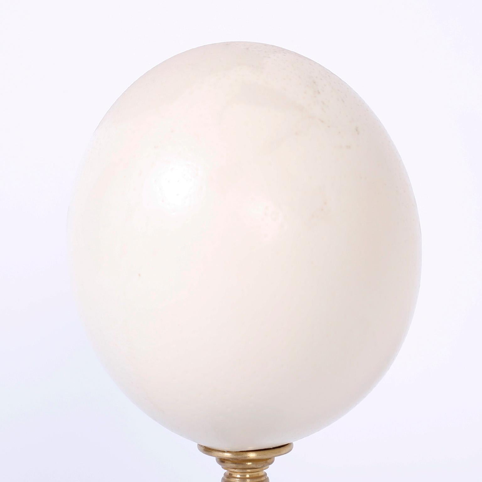 Ostrich egg specimen presented on a Classic stand crafted in brass, turned mahogany and marble.