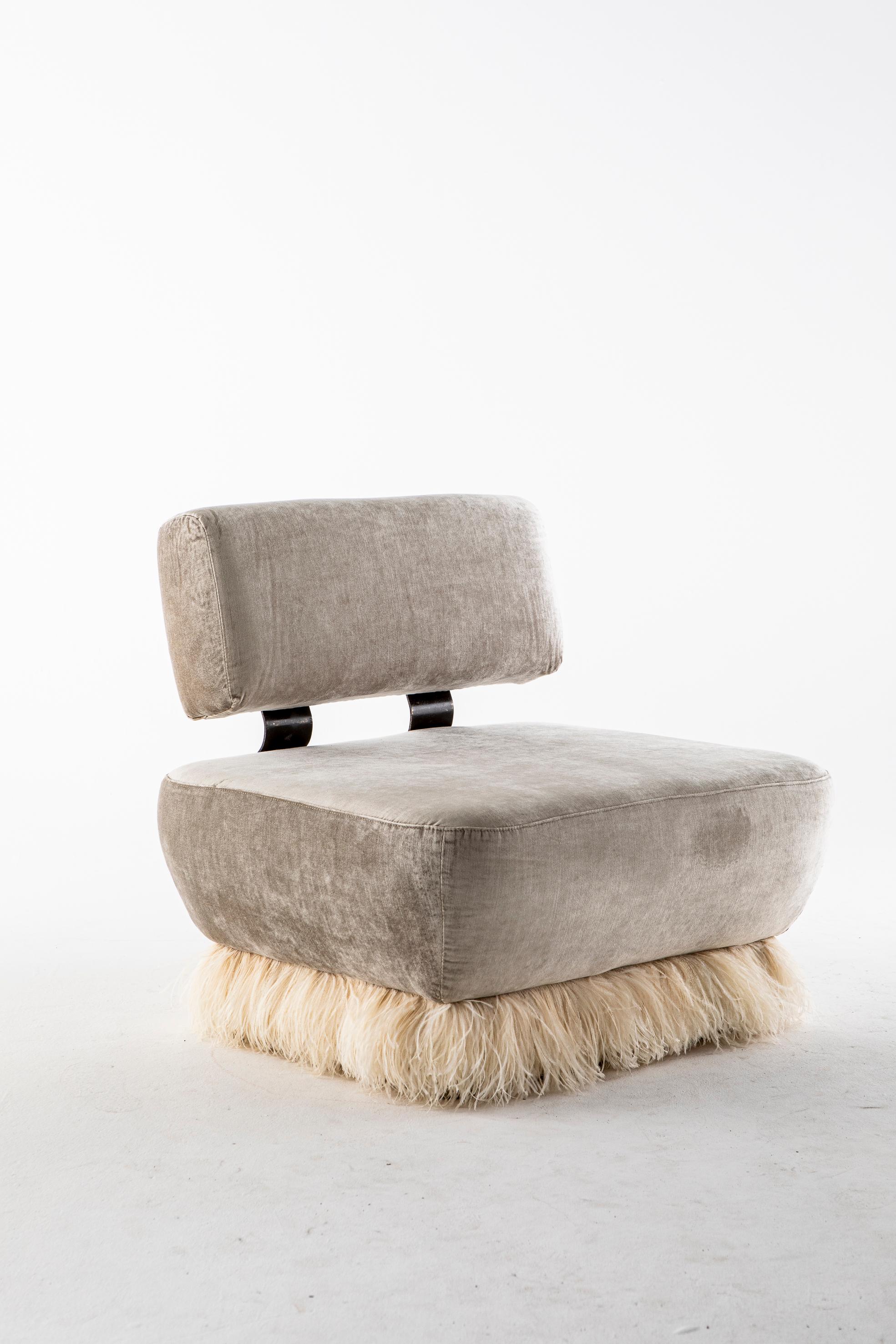 Ostrich fluff lounge chair by Egg Designs.
Dimensions: 92 L X 76 D X 85 H cm
Materials: bronzed steel, brass buttons, ostrich feather trim, velvet upholstery.

Founded by South Africans and life partners, Greg and Roche Dry - Egg is a unique