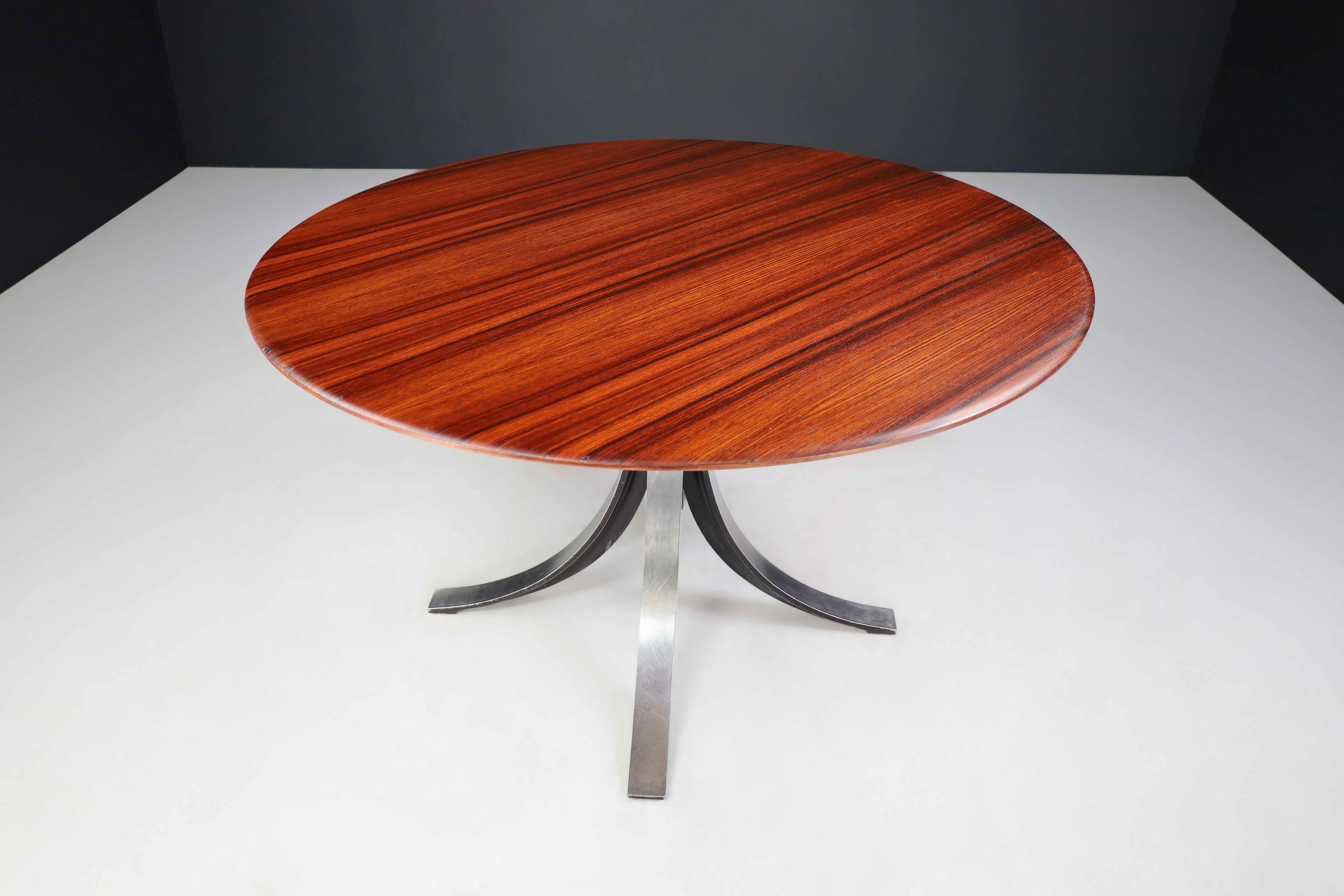 Osvaldo Borsani and Eugenio Gerli for Tecno round dining table in Walnut and Steel Italy, 1965.

This is a round dining table made from walnut and steel by Osvaldo Borsani and Eugenio Gerli for Tecno in Italy in 1965. The table's base is its most