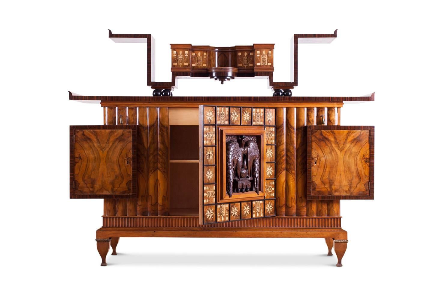 Art Deco Italian exuberance by Osvaldo Borsani.

Extremely decorative piece in walnut, Macassar, ebonized parts and birch inlay
A decorative console rests on top of the sideboard.

A most unusual and high-end Milanese piece from circa