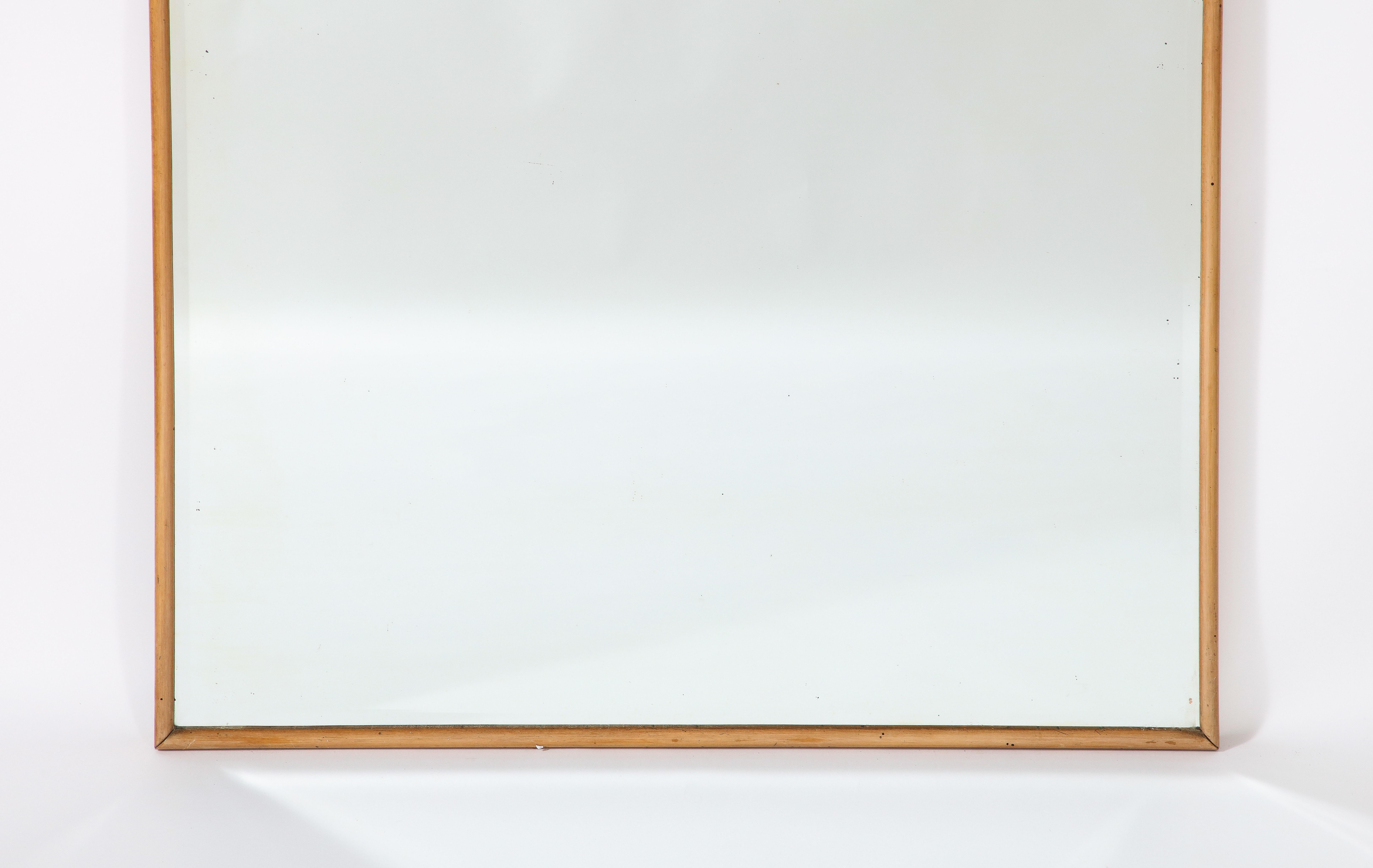 A grand scale beautifully shaped oak framed mirror attributed to the works of Osvaldo Borsani and Varedo Atelier. The beveled mirrored glass is original.  Refined and simple. 

Att. to Osvaldo Borsani, Italy, circa 1950 
Size: 55 1/2