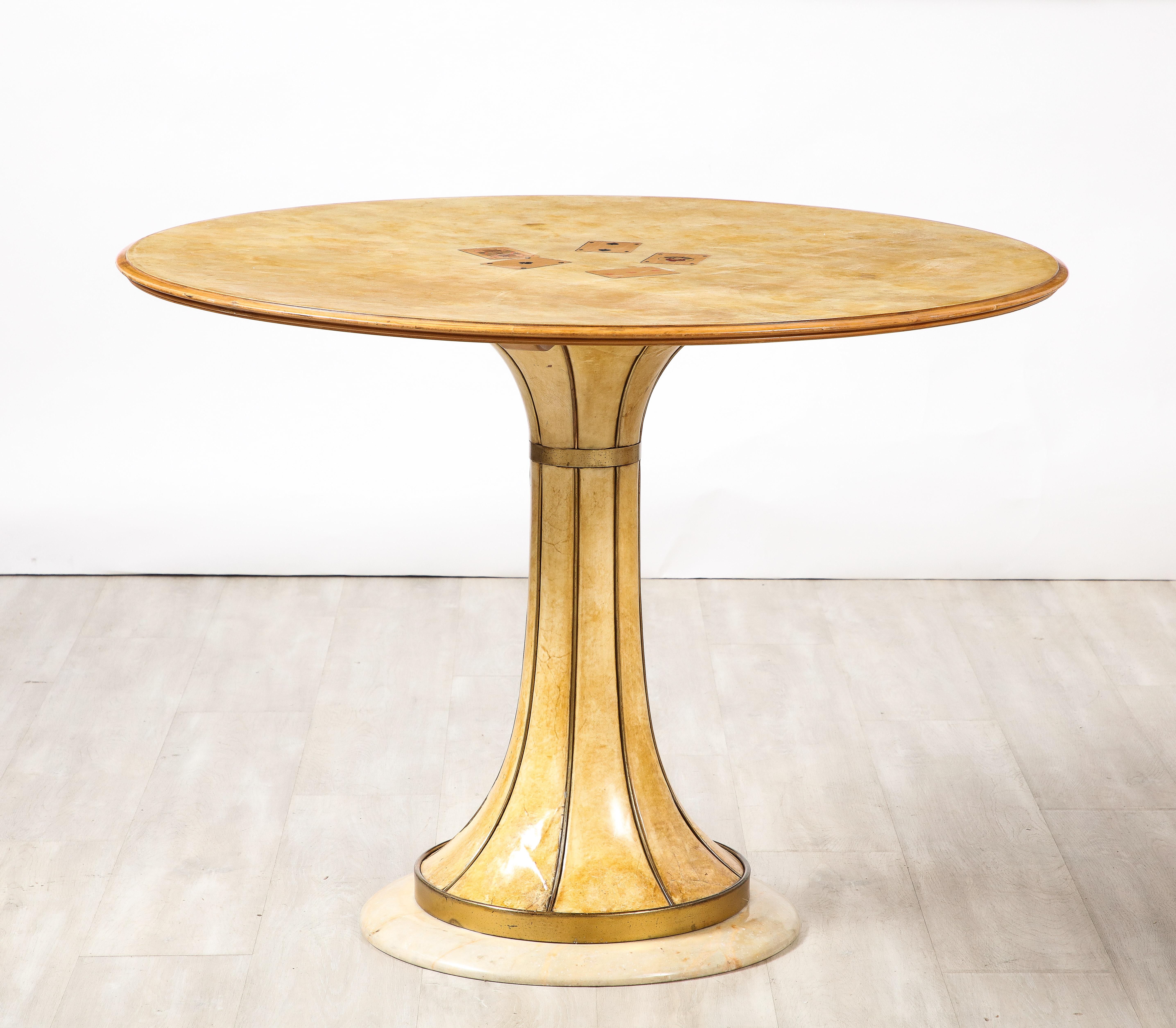 A highly unique and rare masterfully crafted center games table, attributed to the iconic Italian designer, Osvaldo Borsani. The circular top is supported on a vellum tapered pedestal base with brass banding decoration towards the top and at the