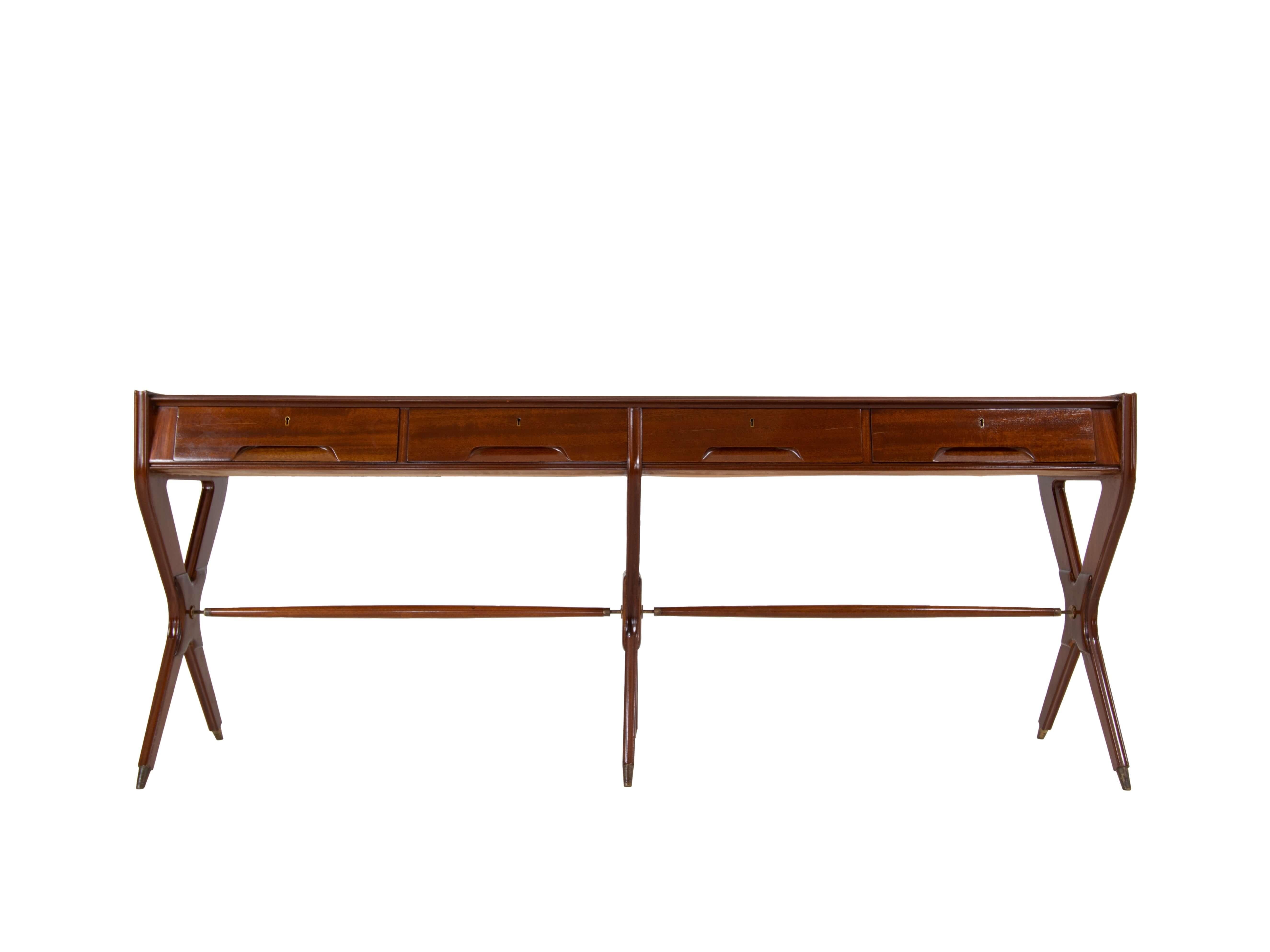 Very rare Osvaldo Borsani console in Mahogany Veneer and Brass, Arredamenti Borsani Italy 1950s. It has four drawers with carved handles. The console has three crossed legs with a horizontal bar and brass feet. The craftsmanship of this console is