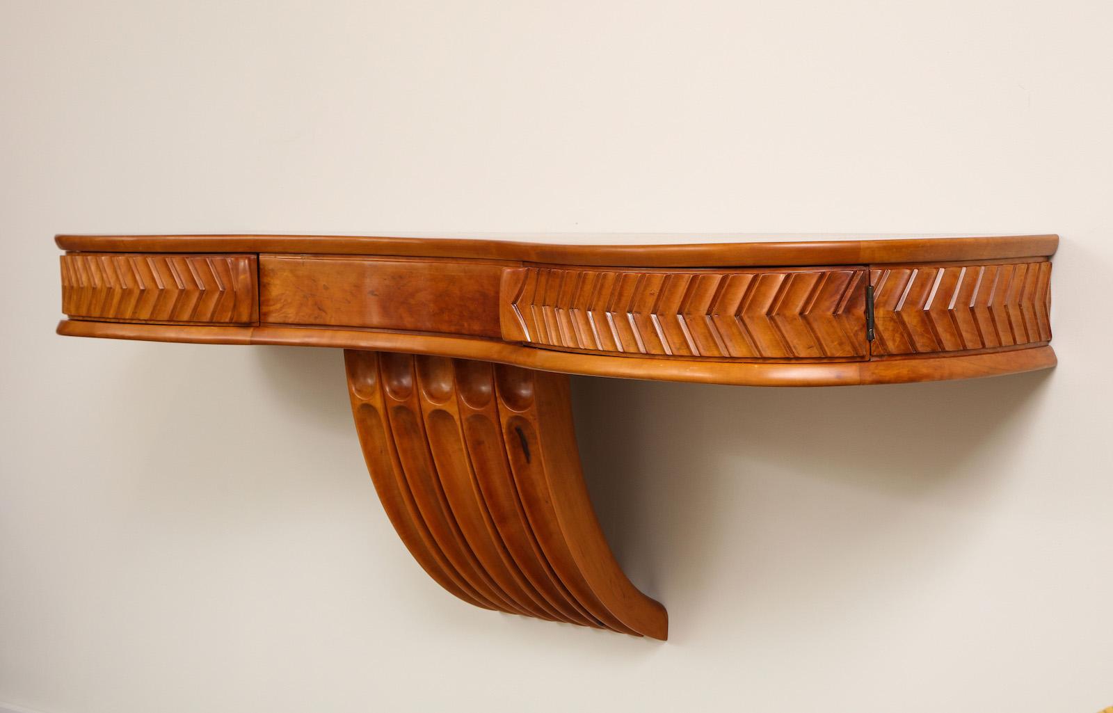 Wall Mounted Console Table by Osvaldo Borsani for ABV.  Console table of maple with carvings, central support & 2 drawers that each open on a concealed pivot.   Wood has recently been refinished.  Authenticated by the Archivio Osvaldo