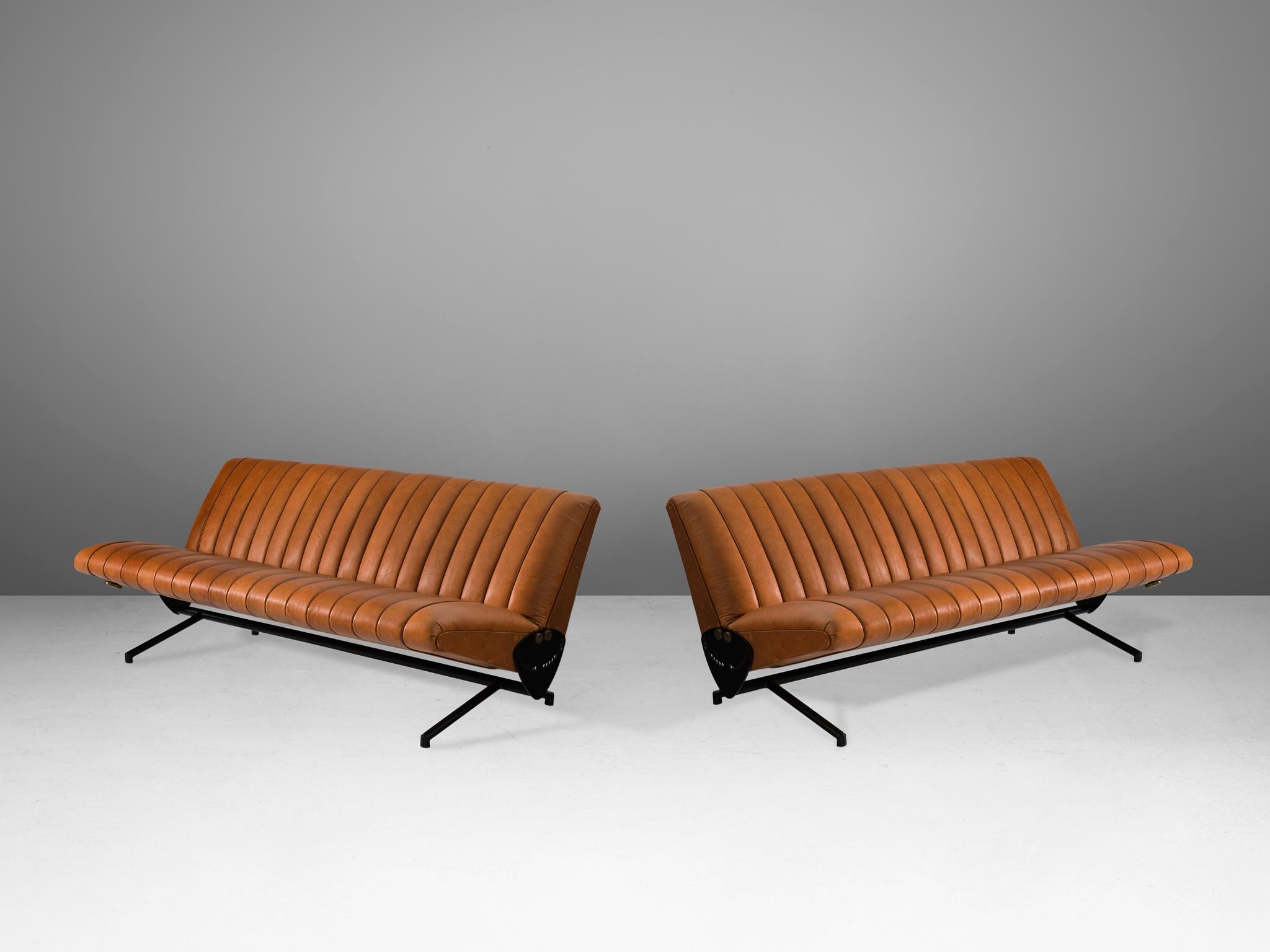 Osvaldo Borsani for Tecno, sofas model D70, in cognac leather, metal and brass, Italy, 1954. 

These iconic sofas by Italian designer Osvaldo Borsani are reupholstered in high-quality brown leather. The vertical stripes of the leather seating