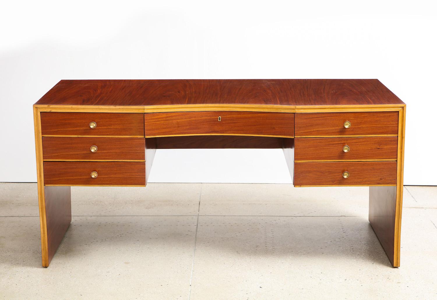 7-drawer desk by Osvaldo Borsani for ABV. Rosewood, maple, brass. Curved desk finished on both sides. A variant of an earlier model that originally covered in parchment and designed for Casa Caminada, 1938. Wood has been refinished.
Published: