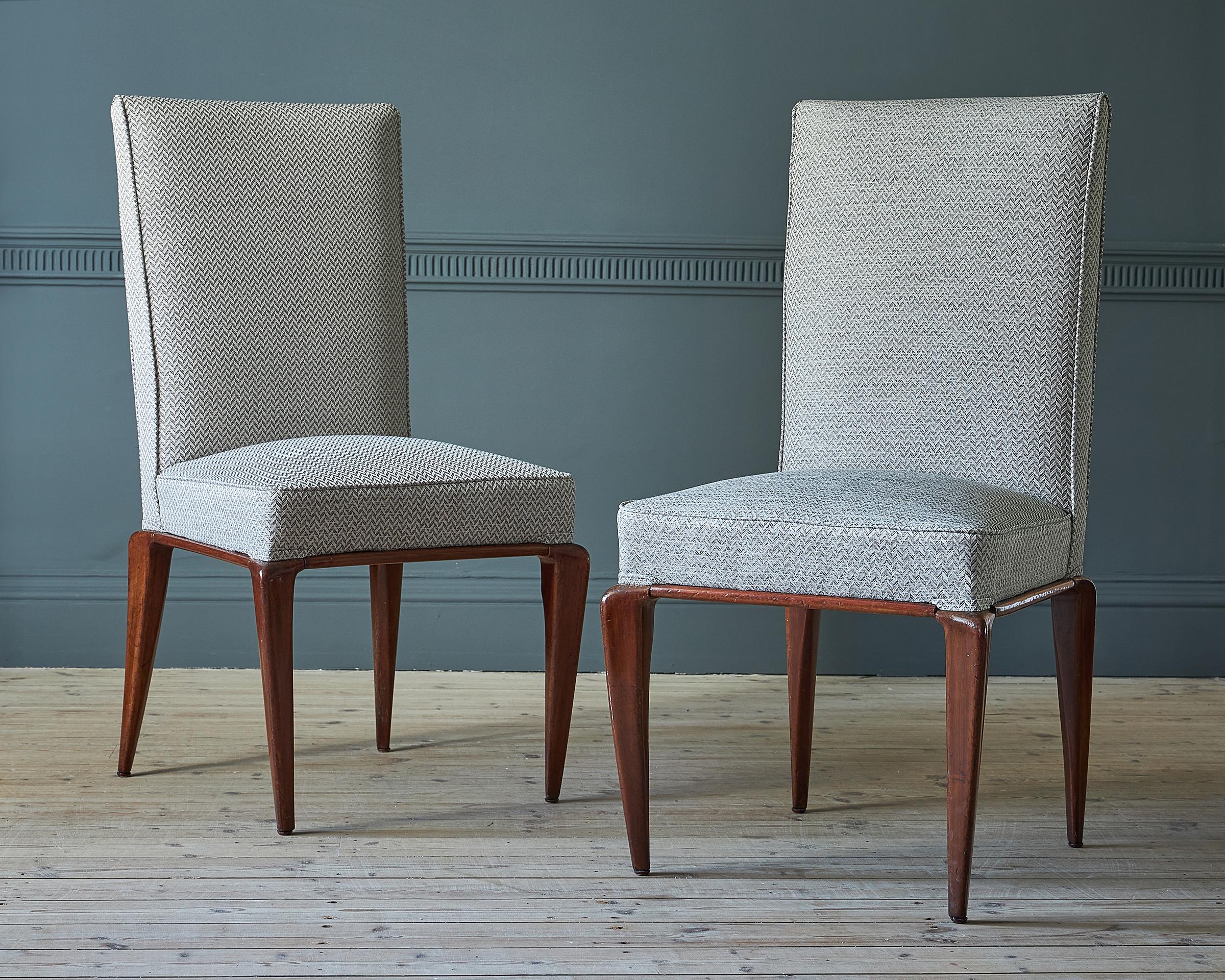 A set of eight Italian walnut dining chairs, attributed to Osvaldo Borsani, circa 1960.