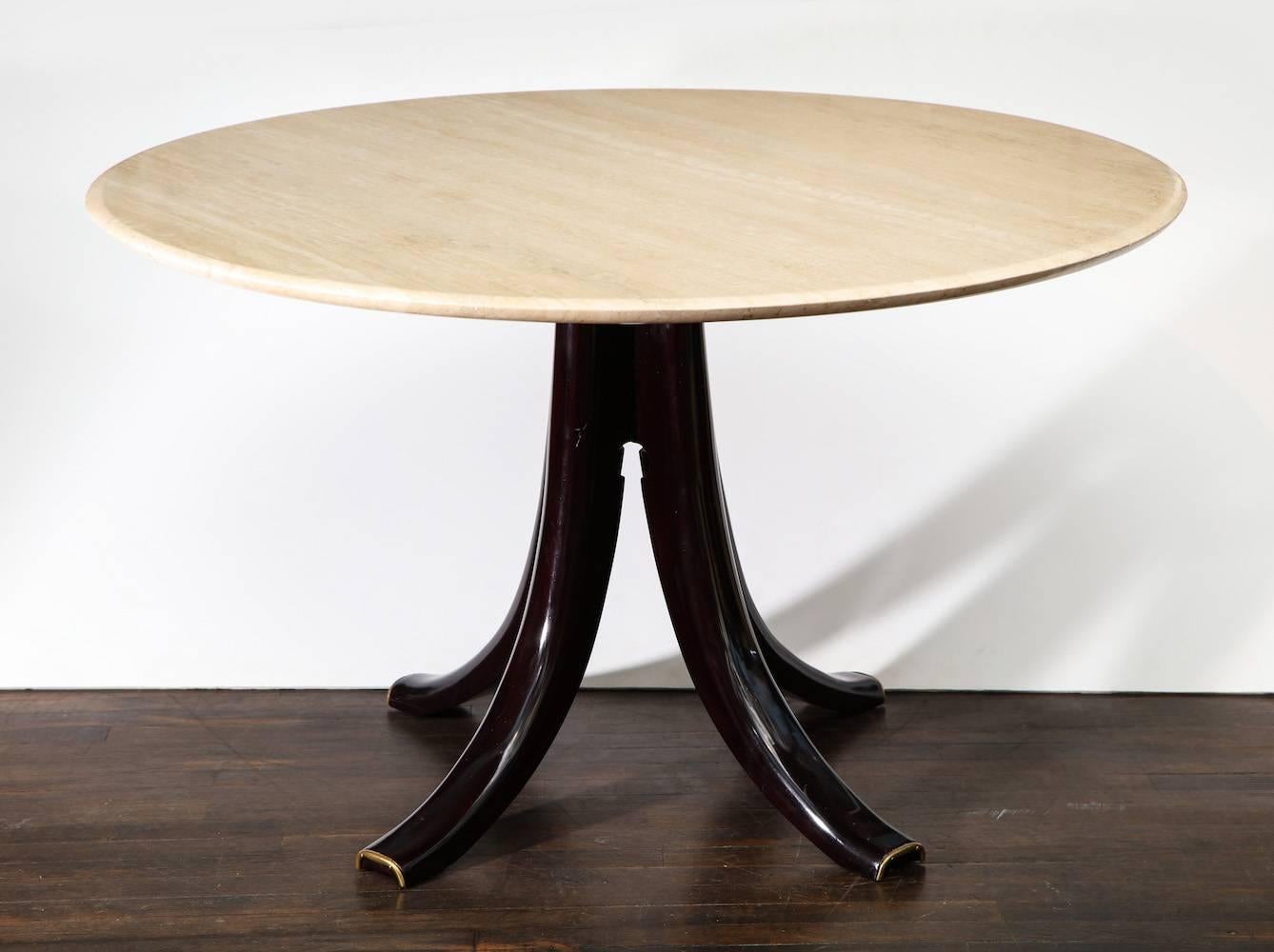 Circular center or dining table by Osvaldo Borsani.
Dark-stained wood base with brass mounts and travertine top. Certificate of Authenticity from Archivio Osvaldo Borsani.