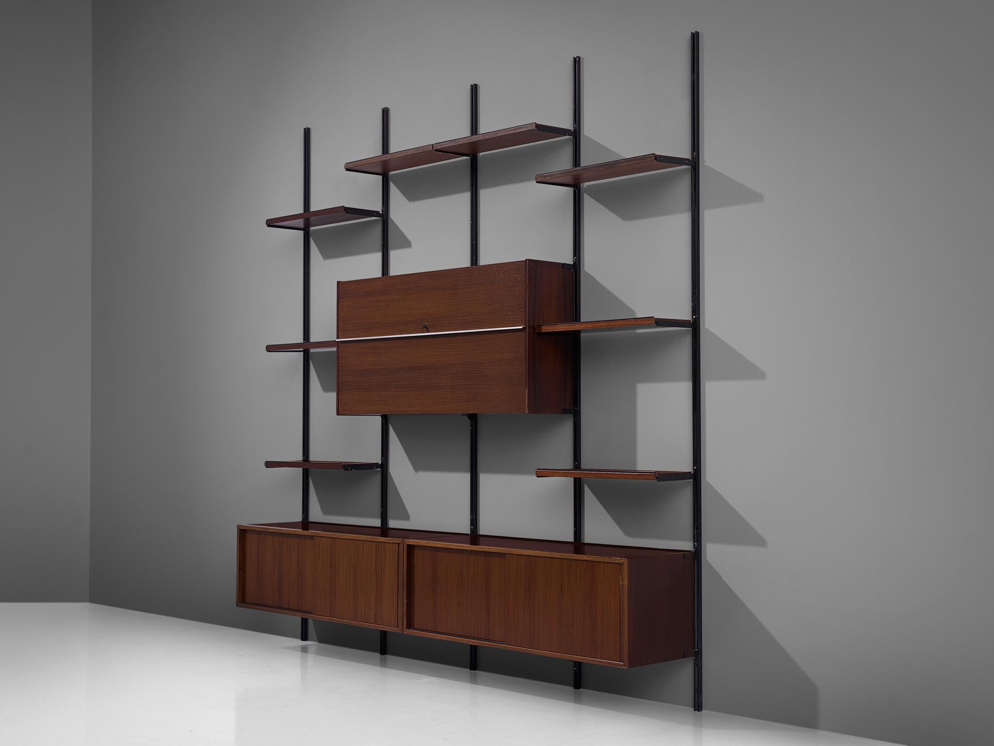 Osvaldo Borsani for Tecno, wall unit, metal and walnut, Italy, 1950s.

Modular shelving system designed by Osvaldo Borsani. The system was developed by Borsani as coordinated system for furnishing either the home or the office, the E22 is composed