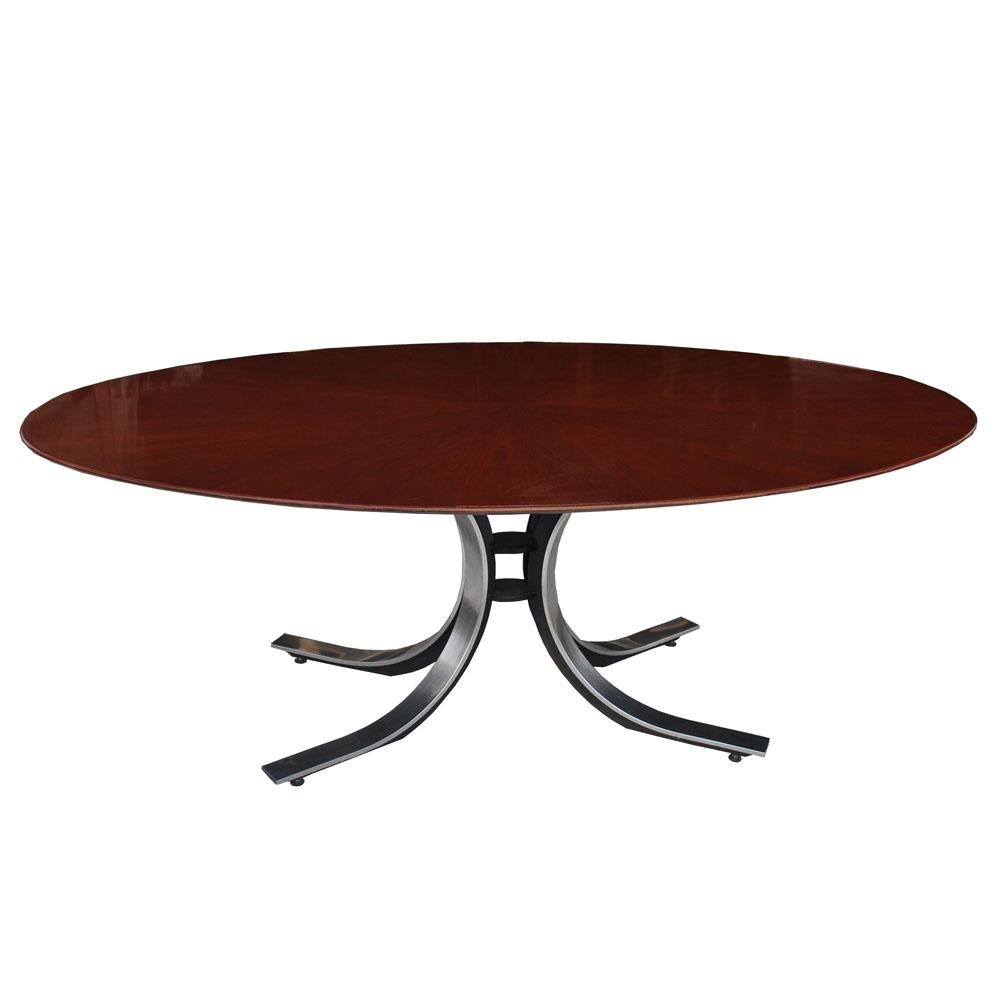 A Mid-Century Modern dining or conference table in the style of Osvaldo Borsani and manufactured by Stow Davis. An oval top in a walnut starburst pattern paired with an elegant Nichol plated steel base with ebonized insets.
 