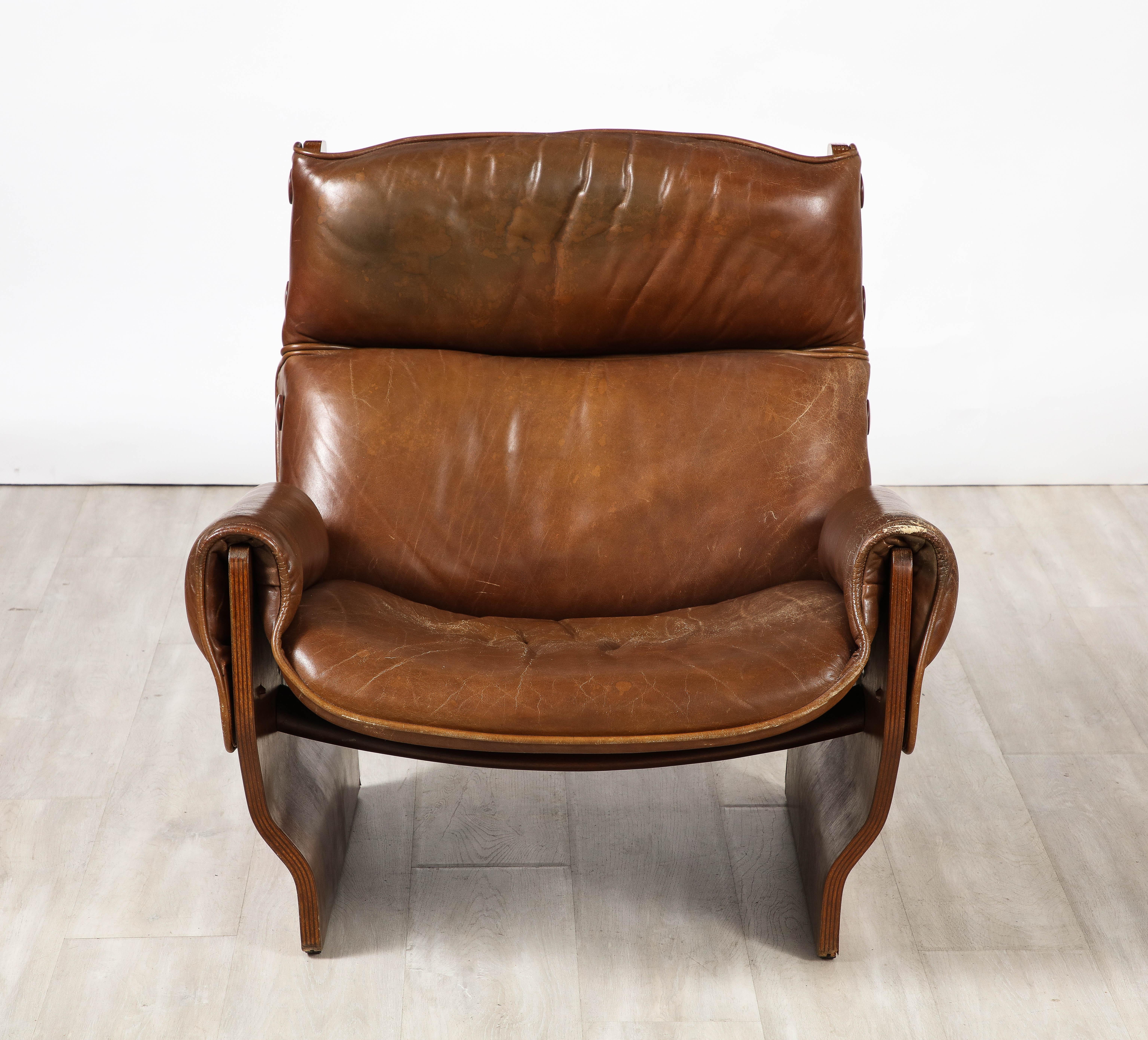 The iconic 'Canada' lounge chair, model P110 designed by Osvaldo Borsani and made by Tecno, Italy, 1965. 

The 'Canada' chair is constructed with two molded walnut side panels and connected with two bentwood cross bars, which holds the frame in