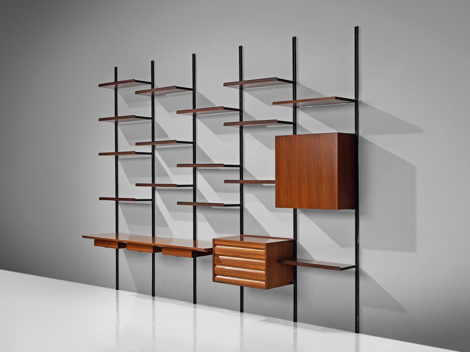 Osvaldo Borsani for Tecno, wall unit E22, metal, Italian walnut, Italy, 1950s.

This wall-mounted shelving unit is five compartments large. This system was developed by Borsani as a coordinated system for furnishing either the home or the office and
