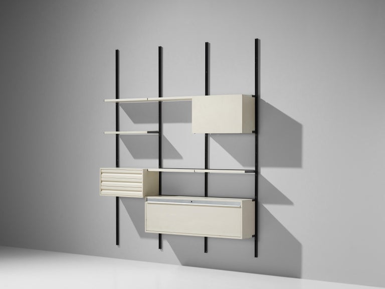 Osvaldo Borsani for Tecno, wall-mounted wall unit, metal, white laminated wood, Italy, 1950s 

This wall-mounted shelf is three compartments large. This shelving system was developed by Borsani as a coordinated system for furnishing either the