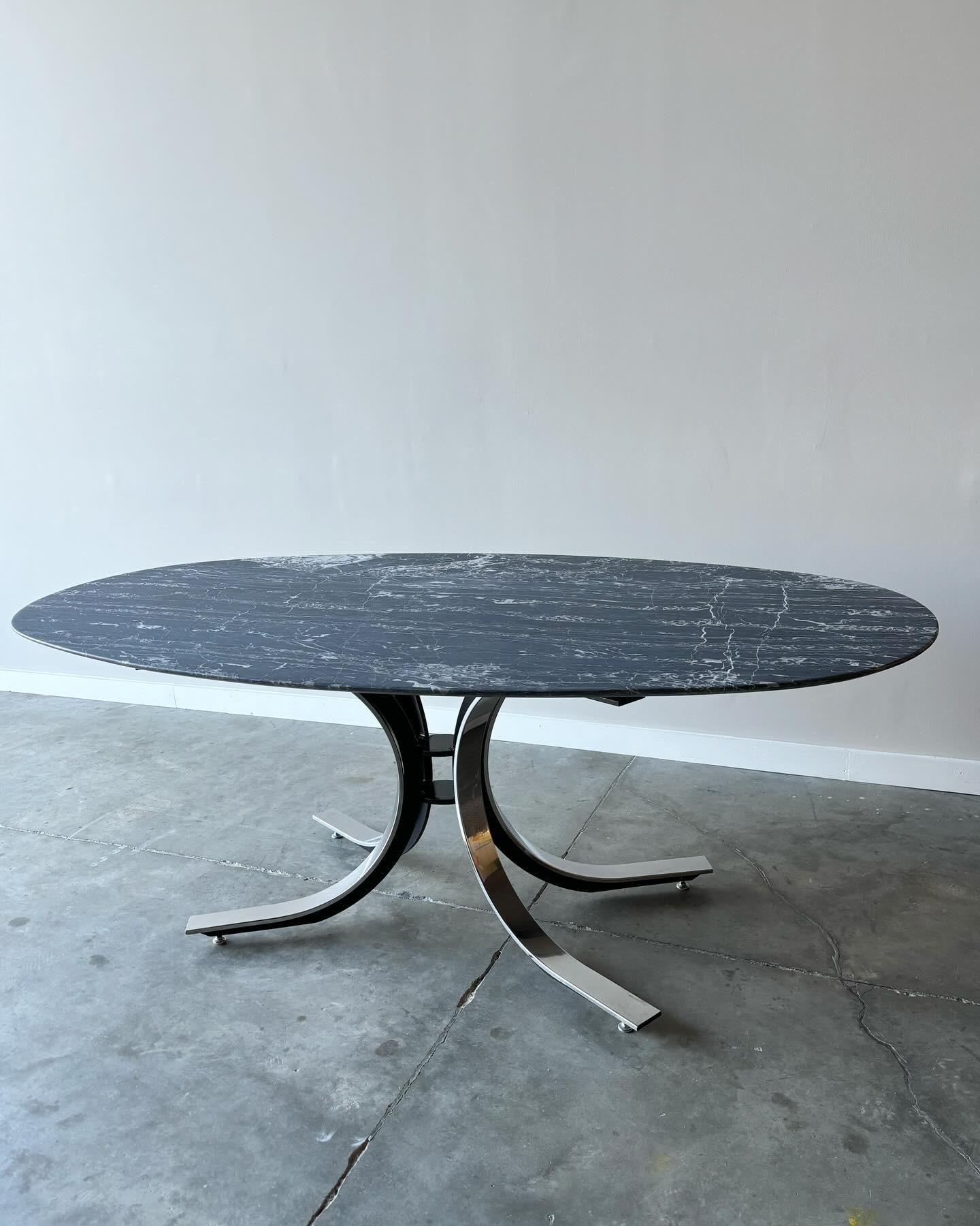 A striking vein pattern to this graphite marble over steel base.  An original Stow Davis table base by Osvaldo Borsani retrofitted with a vintage marble top.  Top is newly refinished to a soft burnished finish.  

