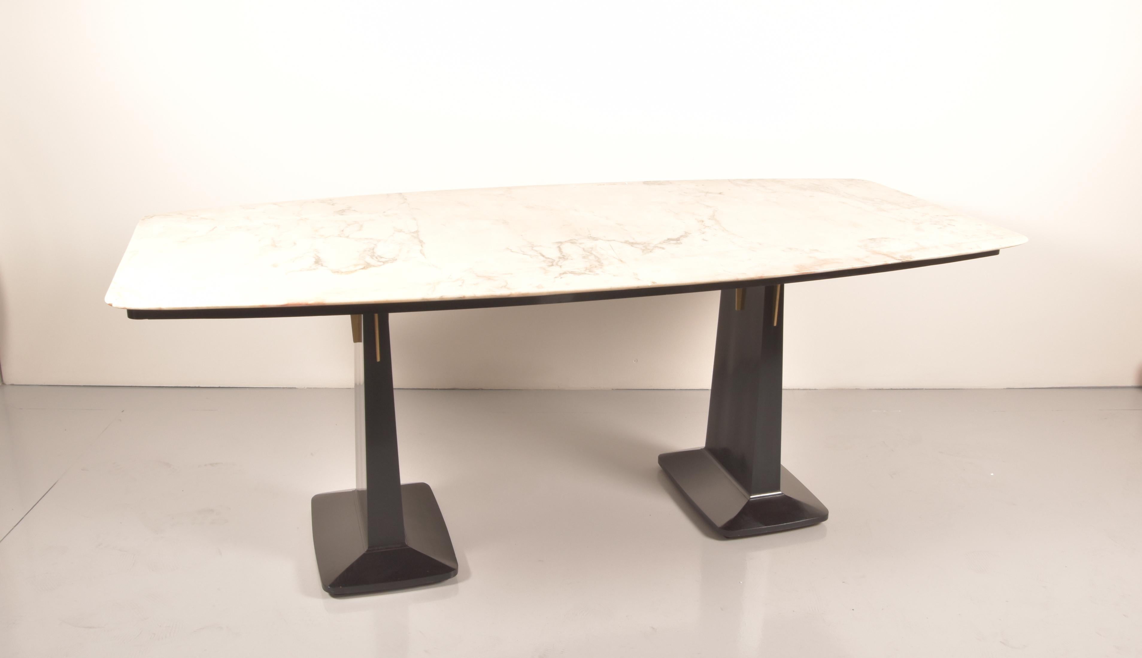 A beautifully ebonized mahogany and rose marble dining table by Arredamenti Borsani Varedo,whit original label, Italy, circa 1950. The wonderful curvature and elegant lines of this table. Comfortably accommodating eight persons, this table really is