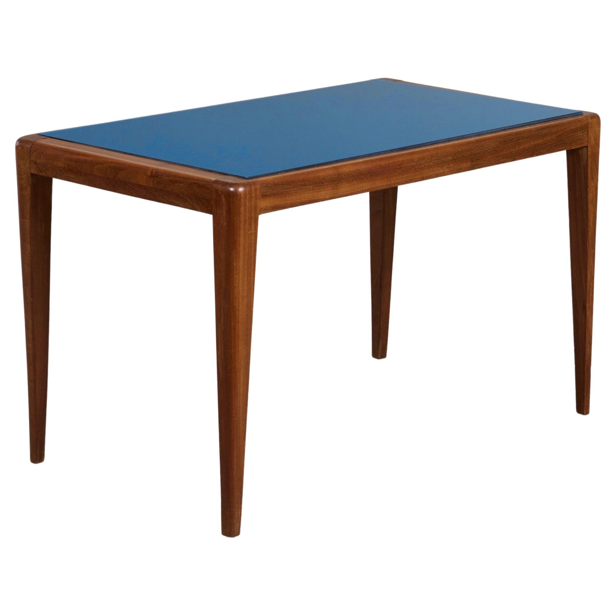 Italy, 1950's

An elegant rectangular side table in the style of Osvaldo Borsani, with a walnut frame cradling a vibrant cobalt blue mirrored glass top, raised on rounded and tapered legs.