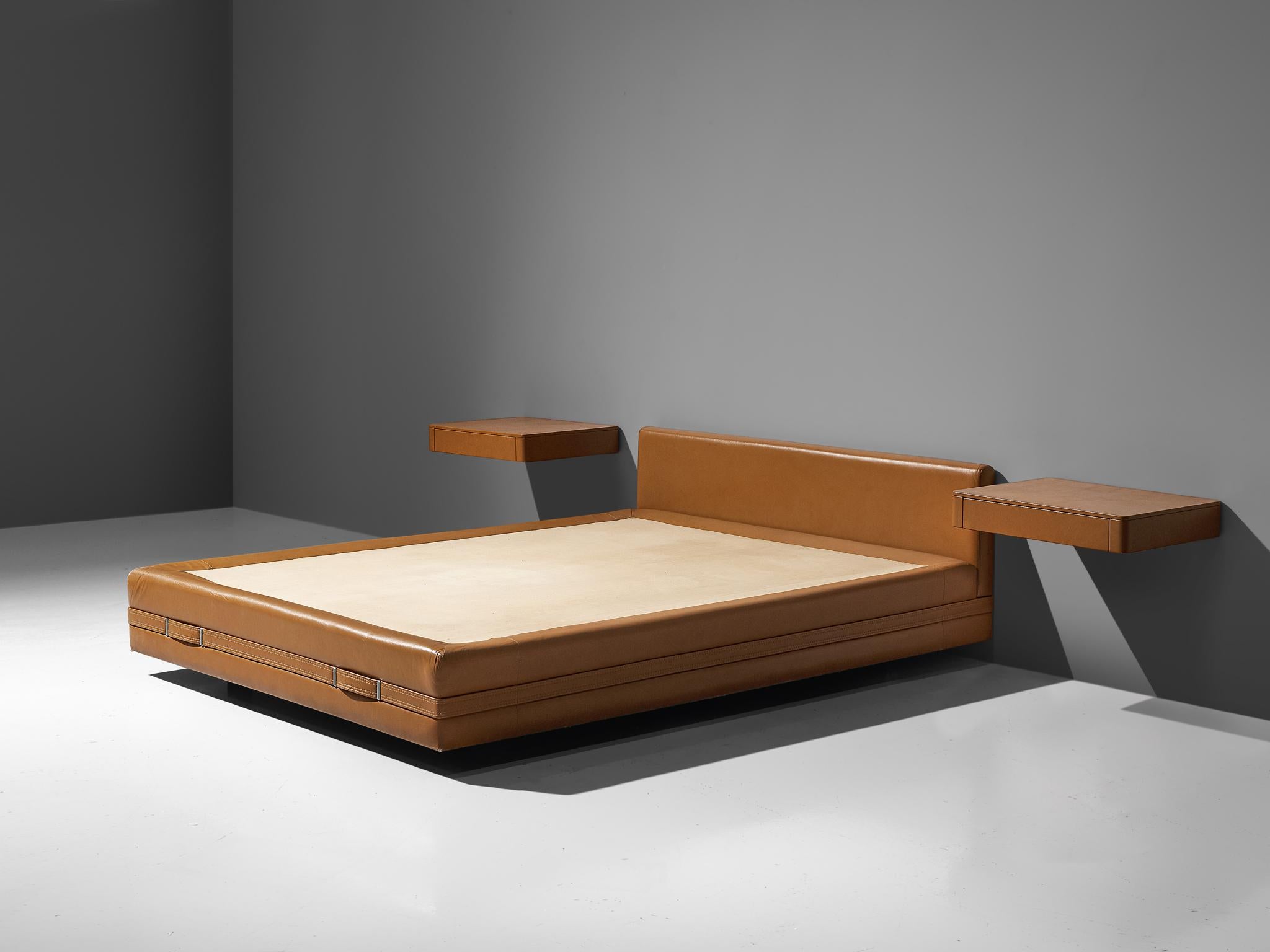 Osvaldo Borsani, queensize bed, cognac leather, metal, Italy, circa 1975.

This Italian bed includes bedframe with headboard, two nightstands and two build in night lights. True example of postmodern design by means of the material used. The