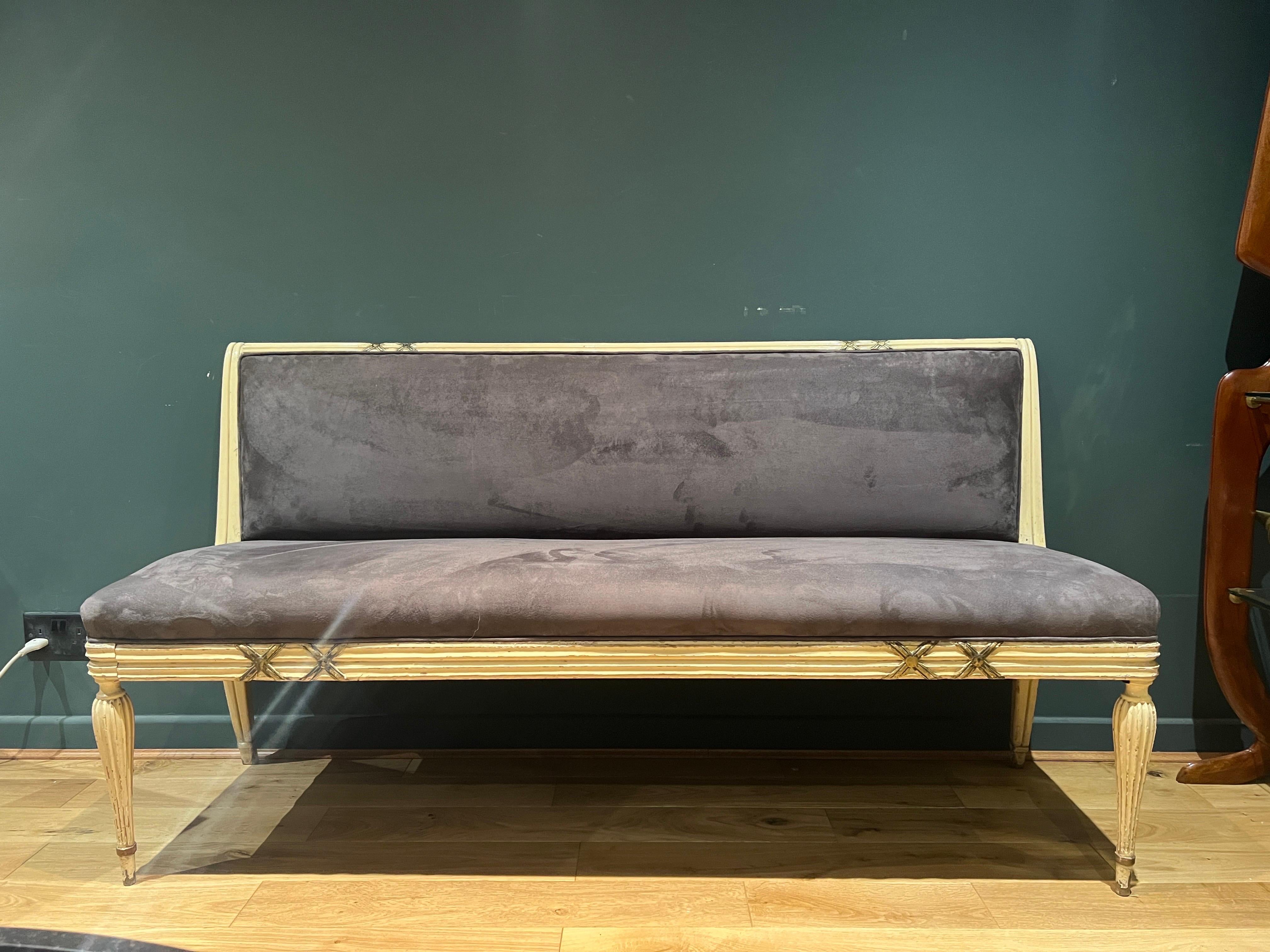 A rare bench designed by Osvaldo Borsani C1950 . The bench retains its original distressed wood in butter cream with gilded X detailing with Beautiful curves to the back . Newly upholstered in grey cotton velvet .  