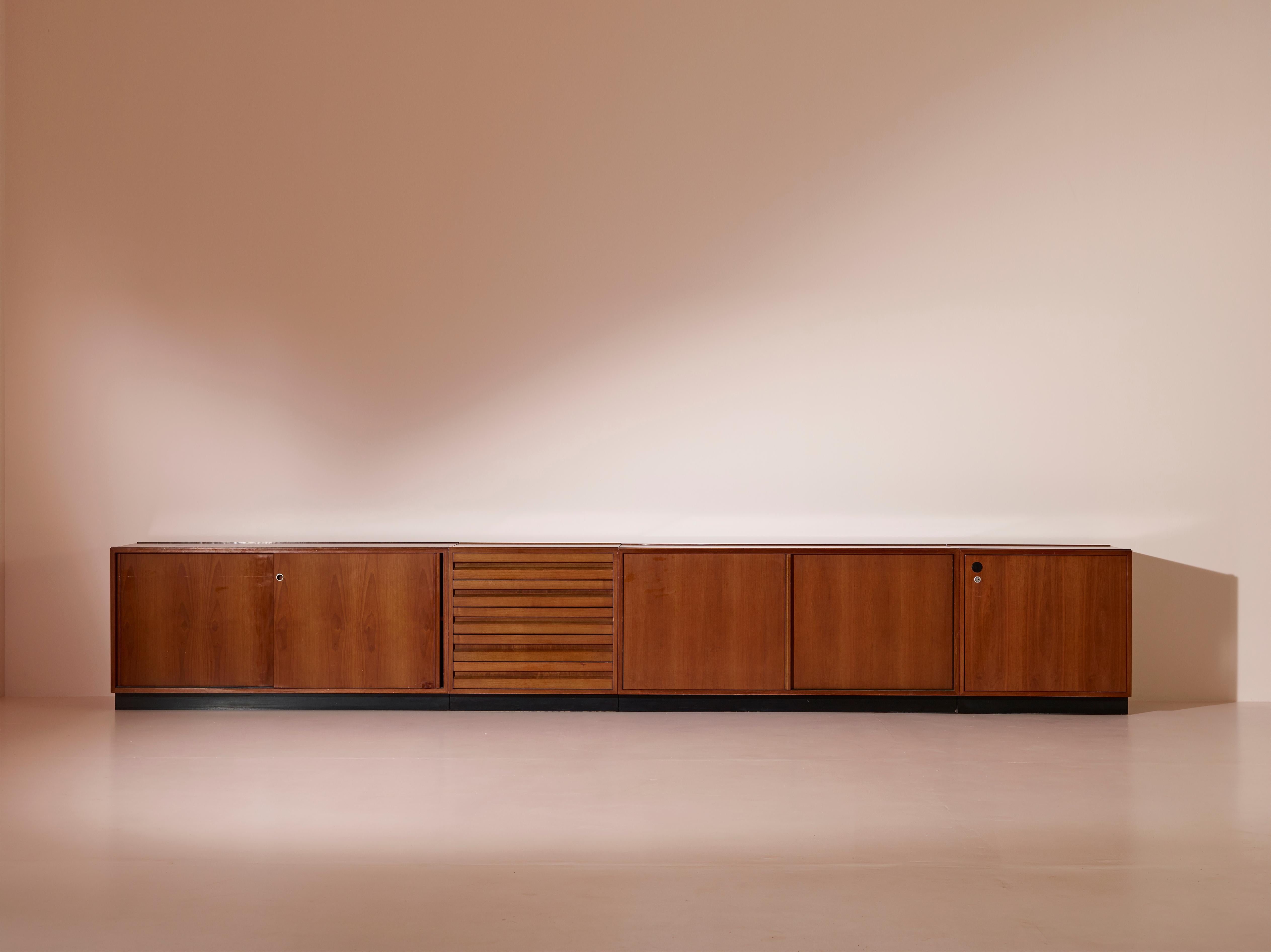 A large modular credenza designed by Osvaldo Borsani and manufactured by Tecno Spa during the late 1950s. 

Crafted predominantly from teak, this modular unit comprises four distinct modules, with precise measurements as follows: two cabinet