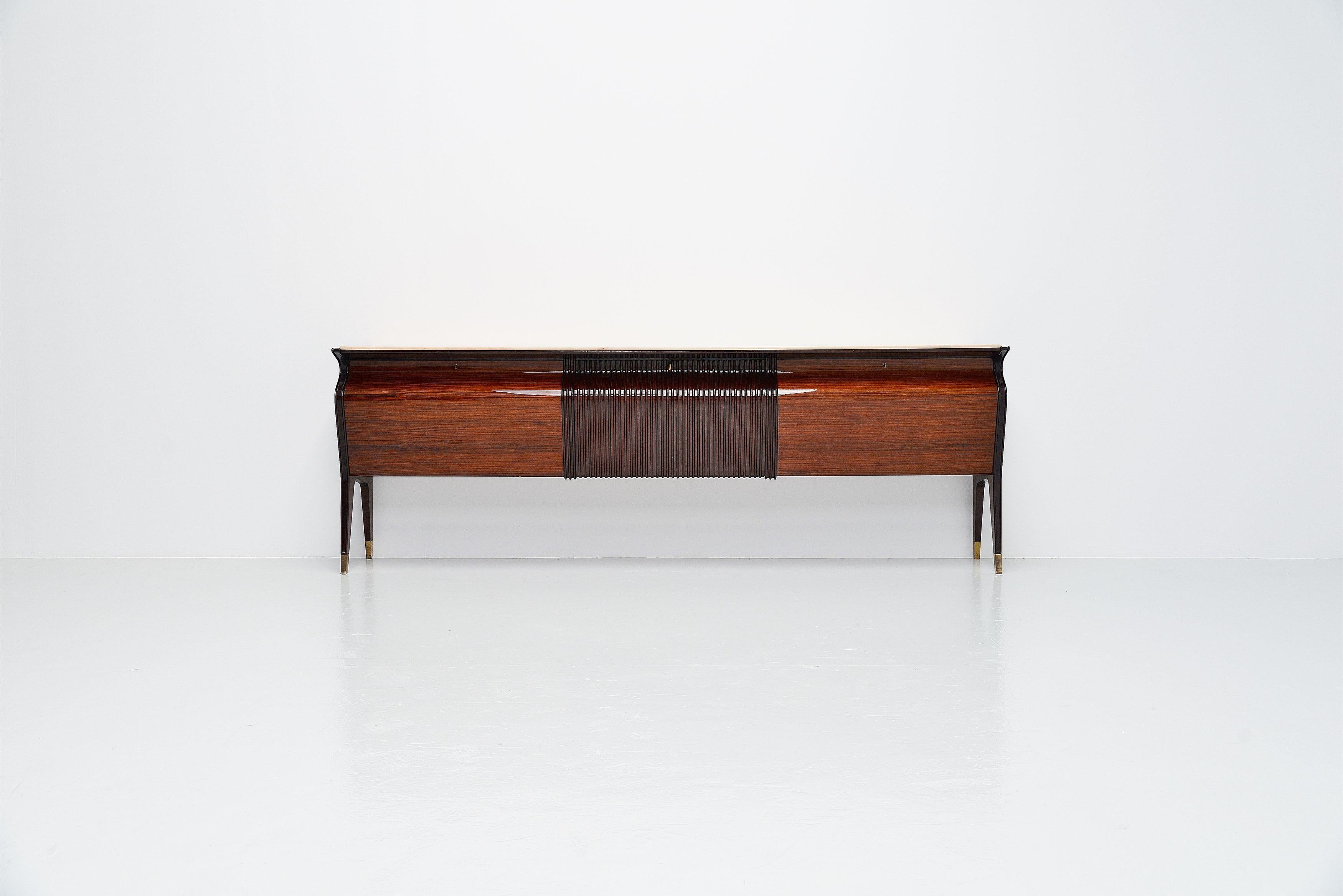 Monumental large sideboard designed by Osvaldo Borsani and manufactured by Mobilificio Fratelli Turri, Italy 1955. This sideboard has rosewood veneer, high gloss finished structure with brass feet. The top is made of marble. The sideboard has