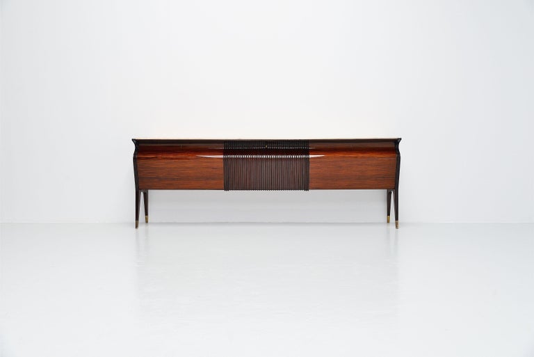 Monumental large sideboard designed by Osvaldo Borsani and manufactured by Mobilificio Fratelli Turri, Italy 1955. This sideboard has rosewood veneer, high gloss finished structure with brass feet. The top is made of marble. The sideboard has