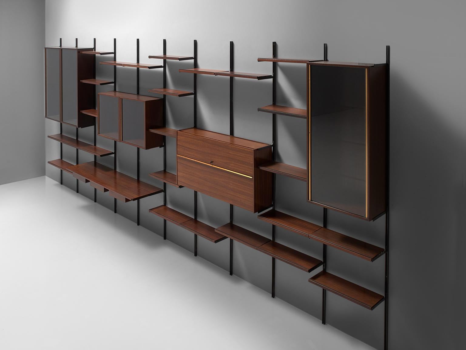 Osvaldo Borsani for Tecno, bookcase or wall unit E22, metal, rosewood and glass, Italy, 1950s.

This wall-mounted shelving unit is ten sections large, with a width of 7 metres. This system was developed by Borsani as coordinated system for