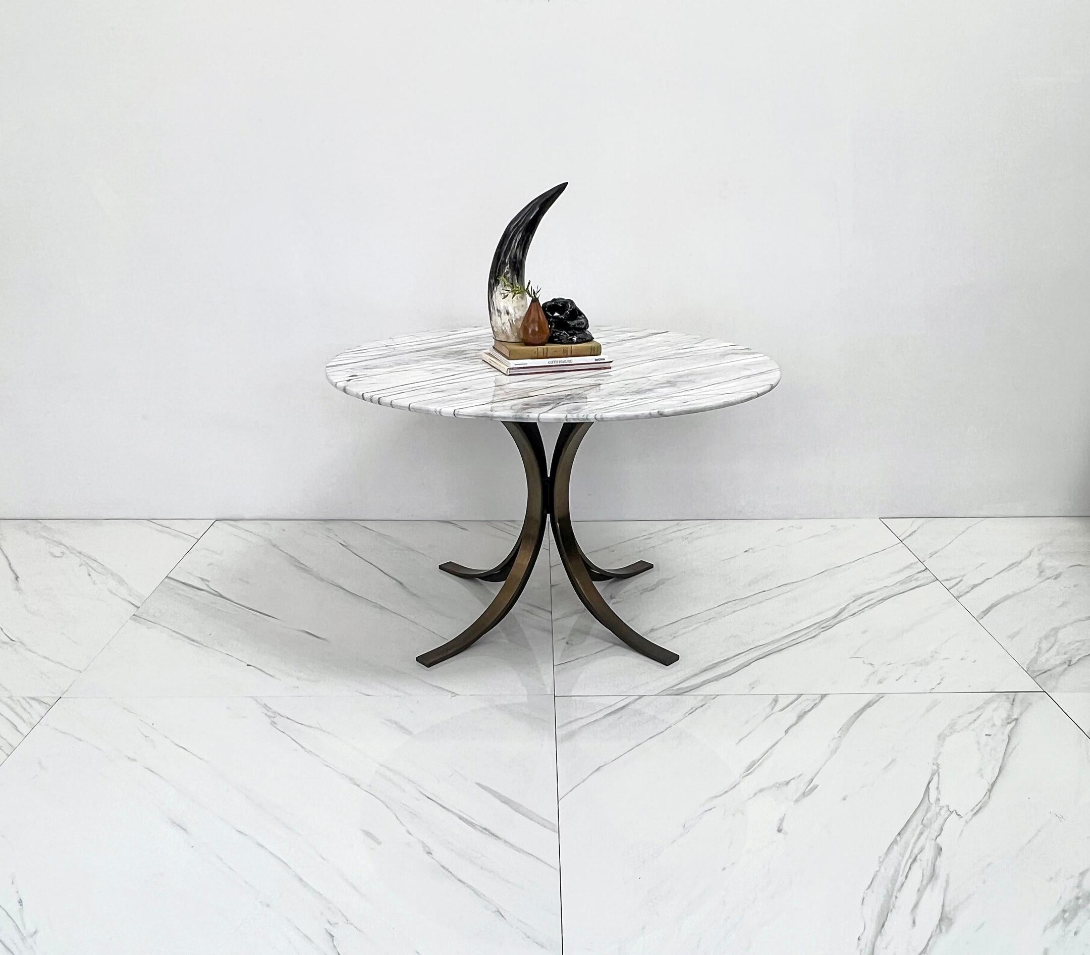 This table is strikingly beautiful. Designed by Osvaldo Borsani for Tecno in the 1970s this table is simple, clean, modern, and timelessly chic. A solid brass flaired out tulip style base, with a round 50
