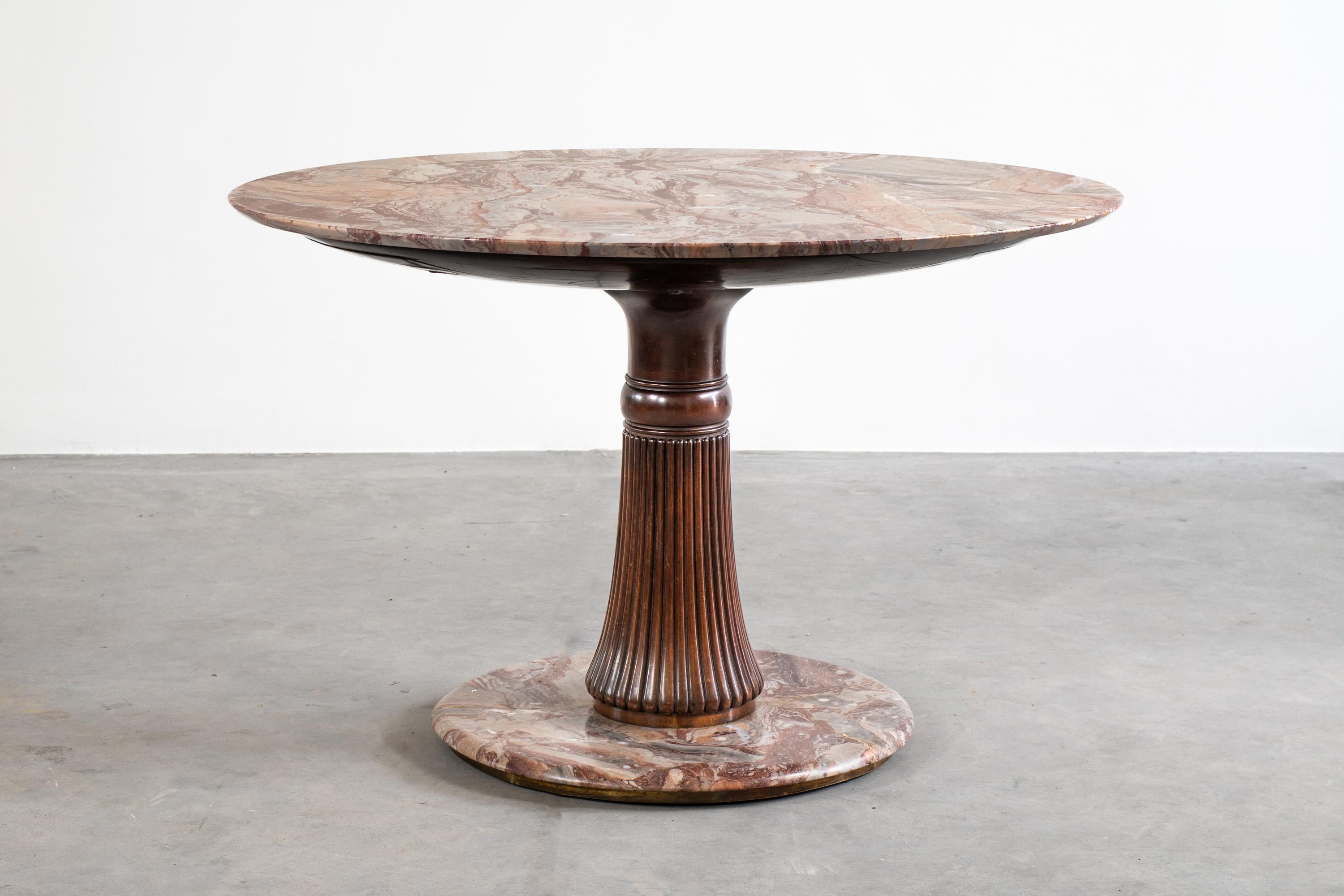 Beautiful round table from the 1950s designed by Osvaldo Borsani, 
with central support in carved wood and top in pink marble by Macchiavecchia.

  