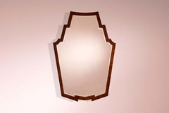 Mirror with walnut frame and shaped mirrored glass, Italy, 1940s