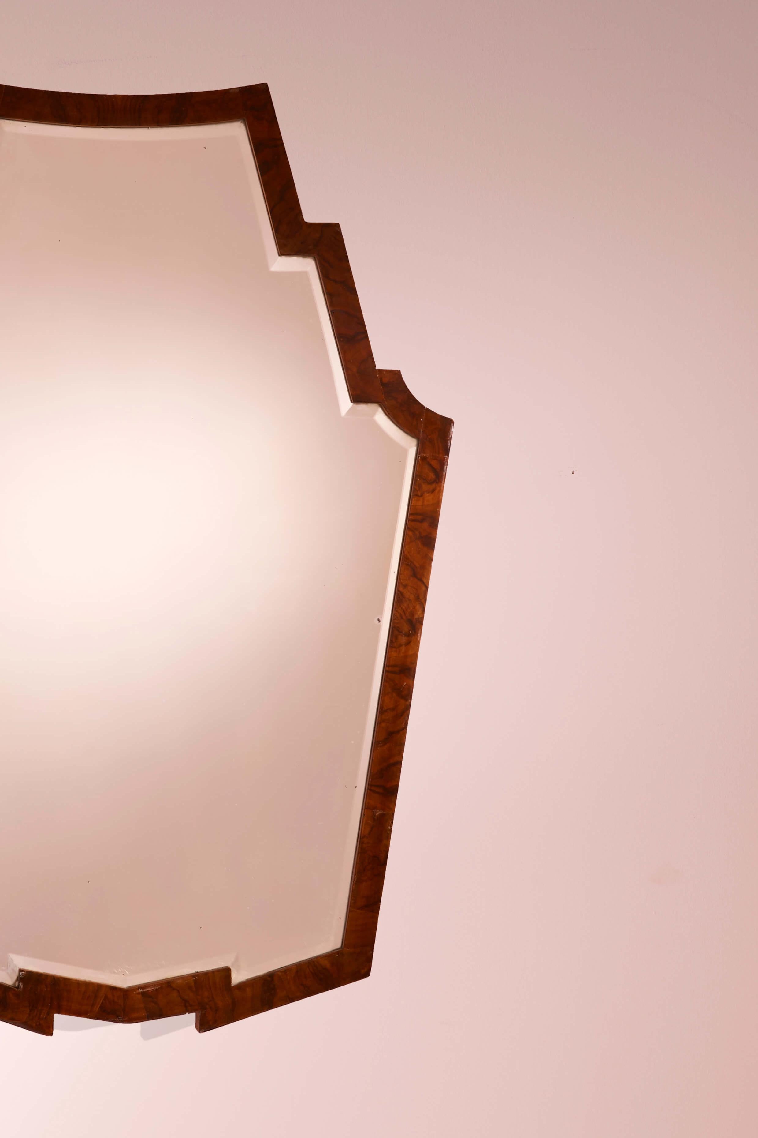 Italian Mirror with walnut frame and shaped mirrored glass, Italy, 1940s For Sale
