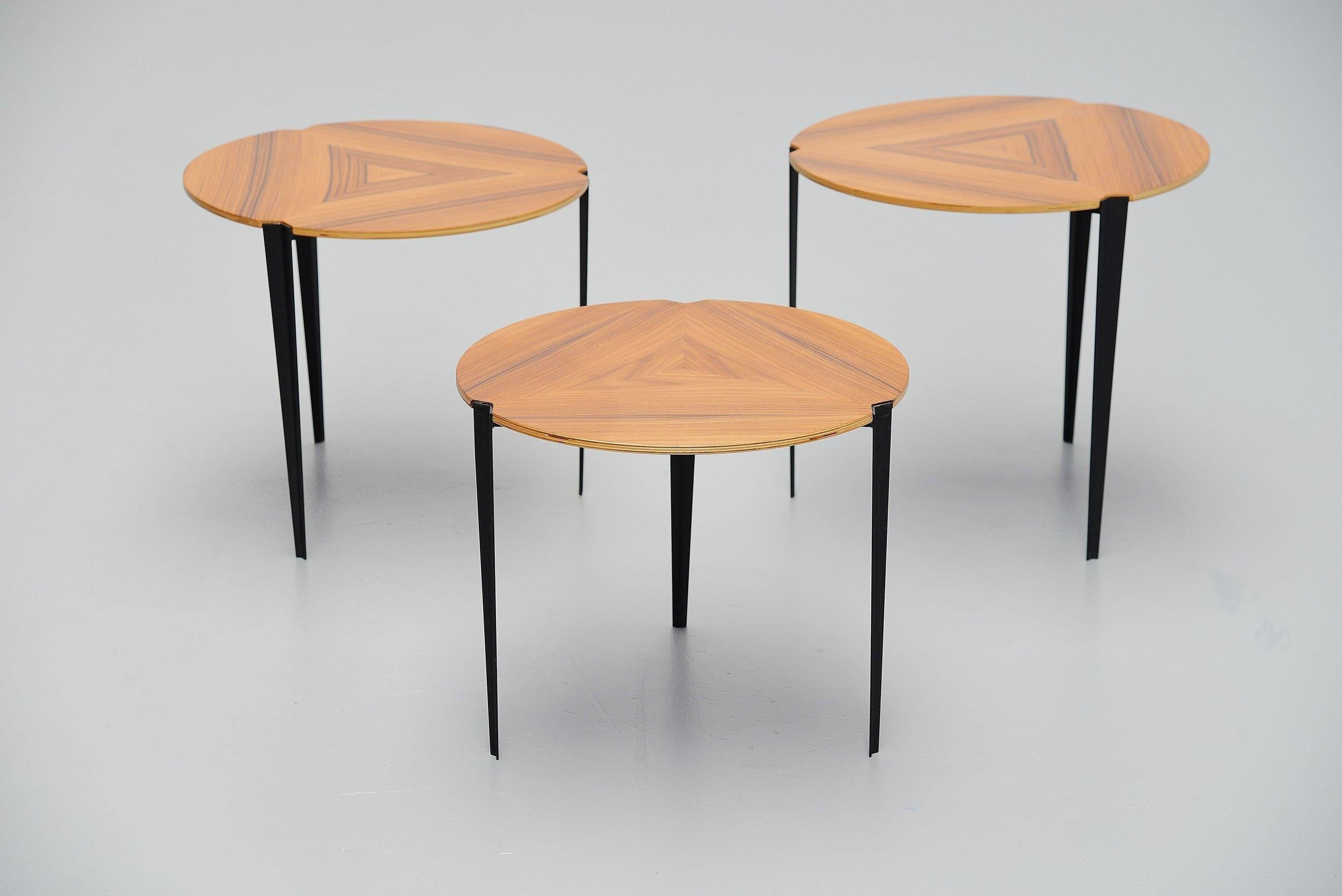 Nesting table set model T61E designed by Osvaldo Borsani and manufactured by Tecno, Italy 1957. The 3 tables have a v shaped black painted metal frame that slides in each other and the tops are made of walnut veneer. These tables have a fantastic