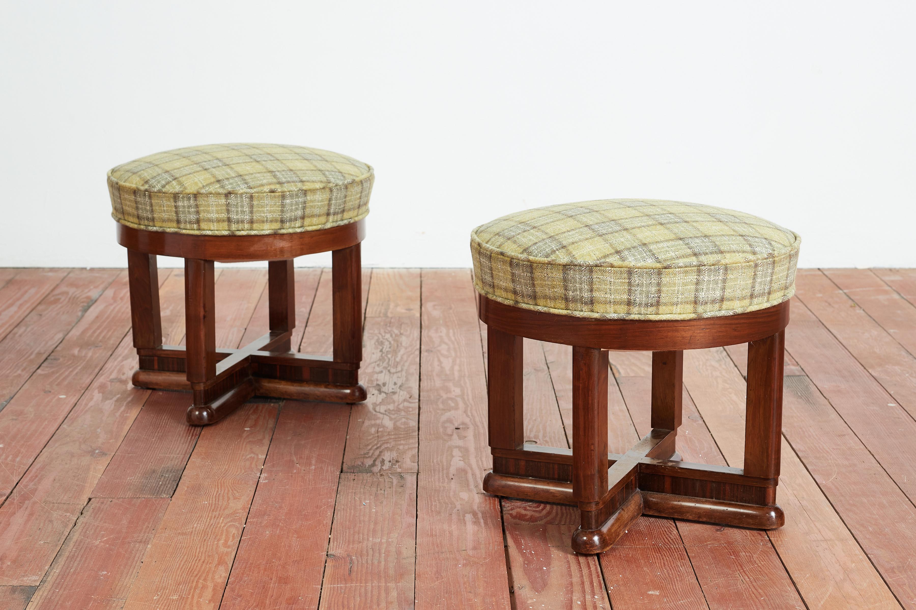 Wonderful pair of Osvaldo Borsani ottomans newly upholstered in green tartan wool fabric.
Wonderful patina to rich mahogany wood bases with inlay and curved feet. 

Italy circa 1940s 