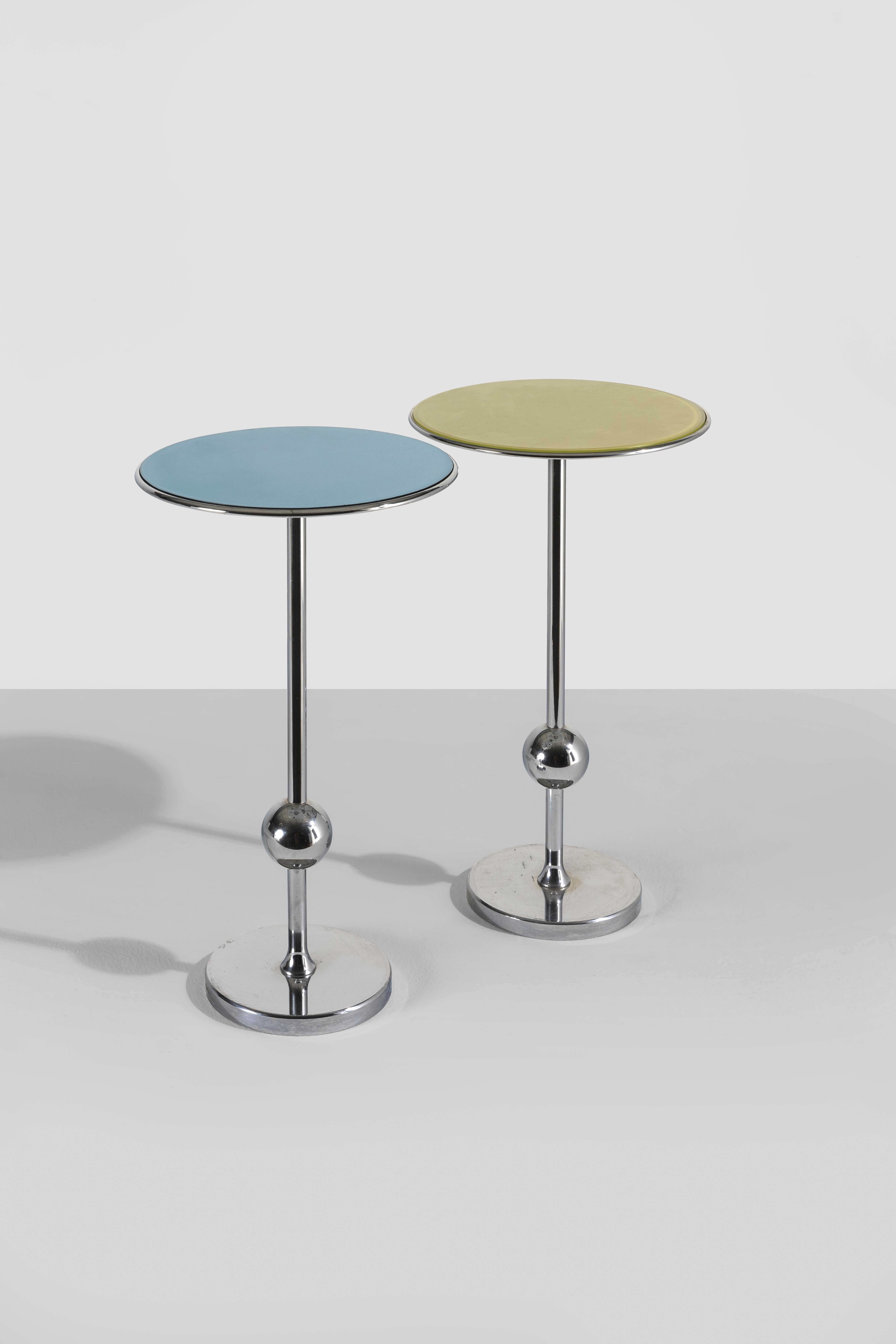 Pair of gueridons that are fun, interesting and decorative in their simplicity. The chrome structure contrasts with the colored glass top, creating a very decorative and attractive color play. The 1949 design is a trait clearly traceable to the